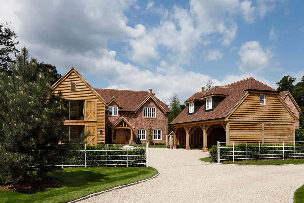 Timber-framed carport beside a house