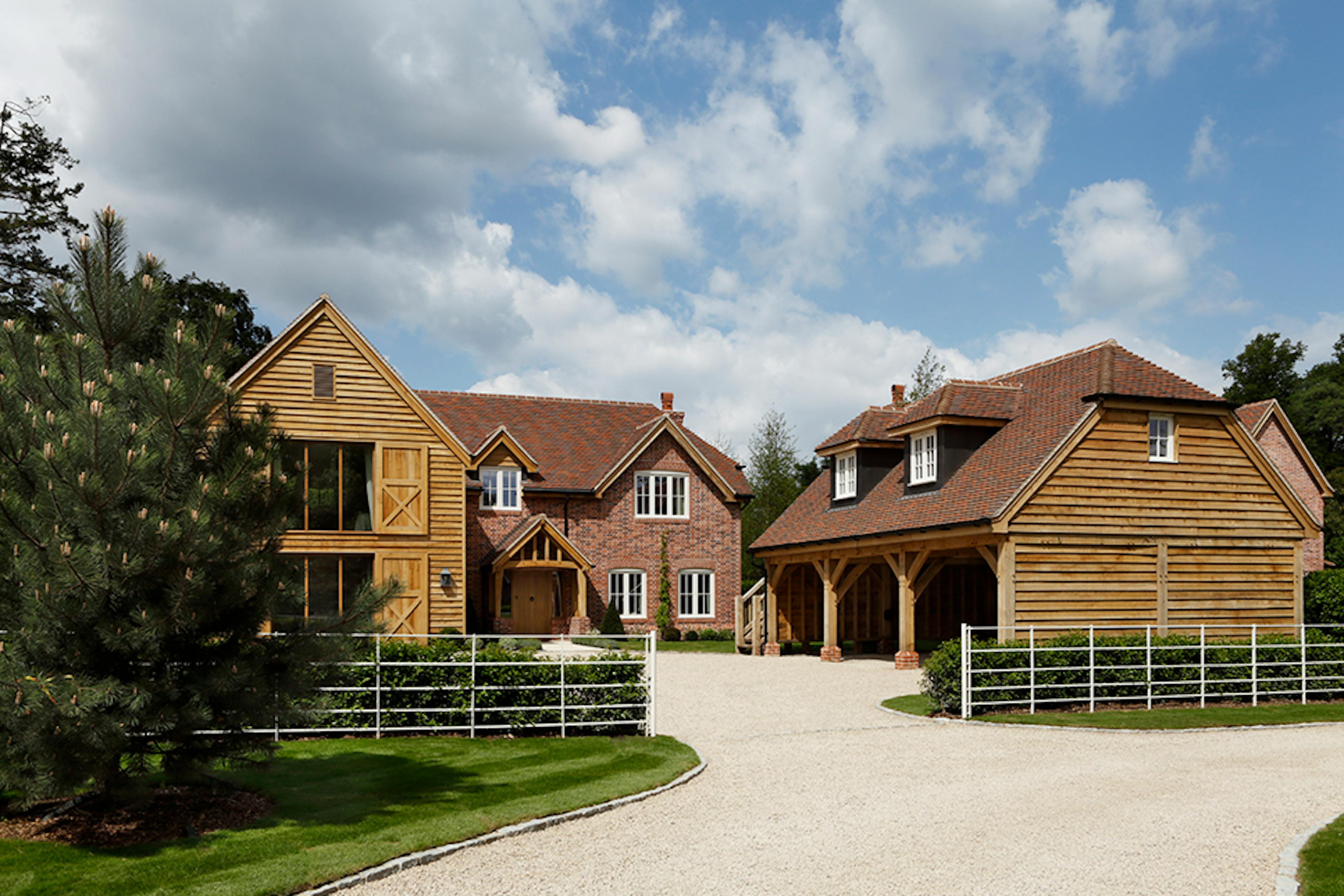 Timber-framed carport beside a house