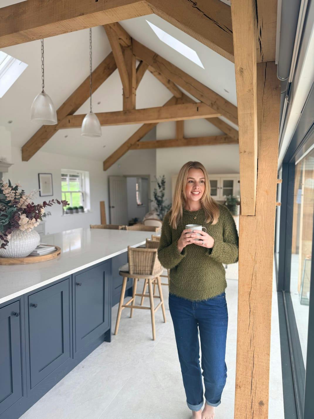 Image of a Leonie Wroe in her oak framed kitchen diner