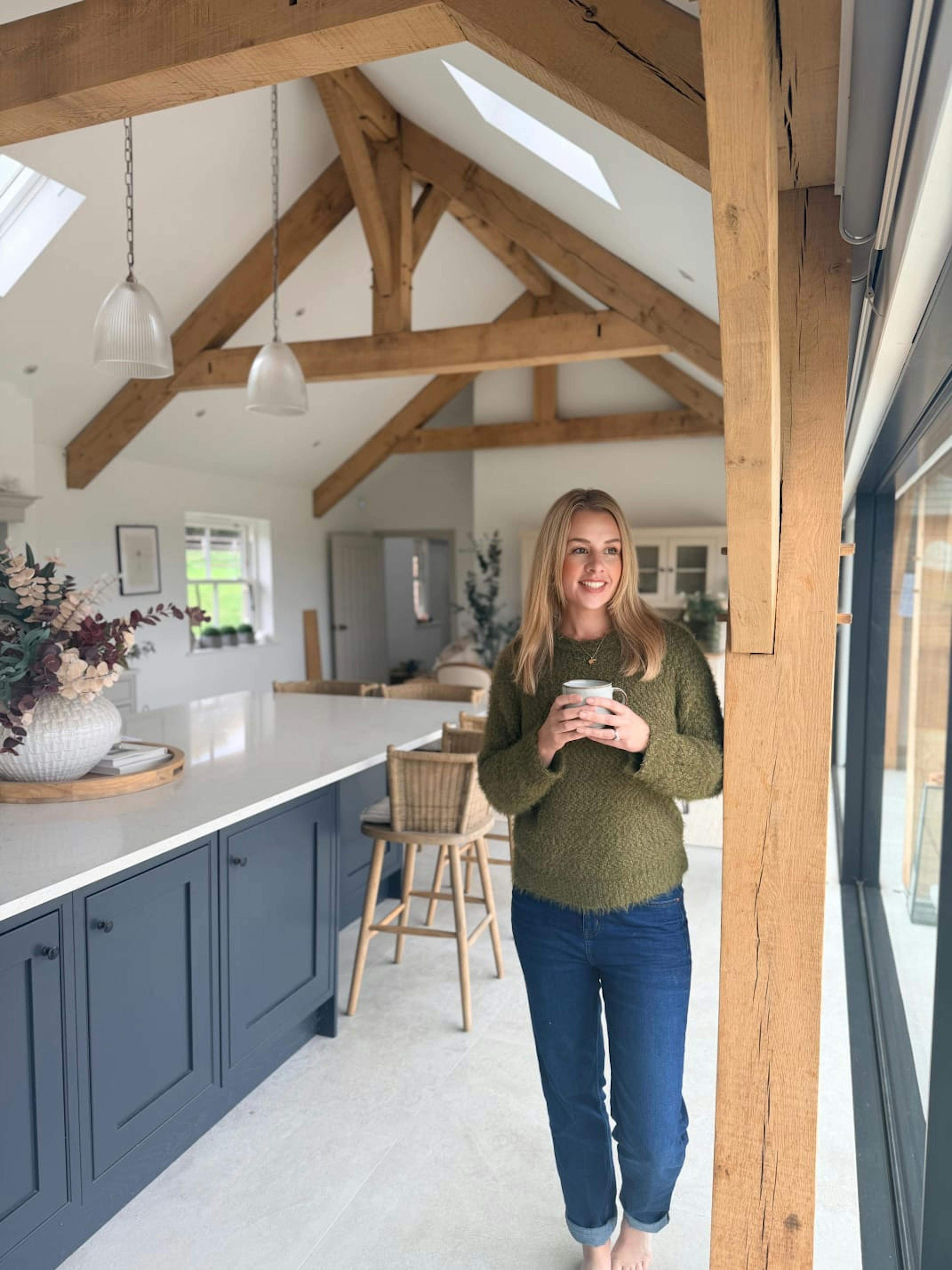 Image of a Leonie Wroe in her oak framed kitchen diner