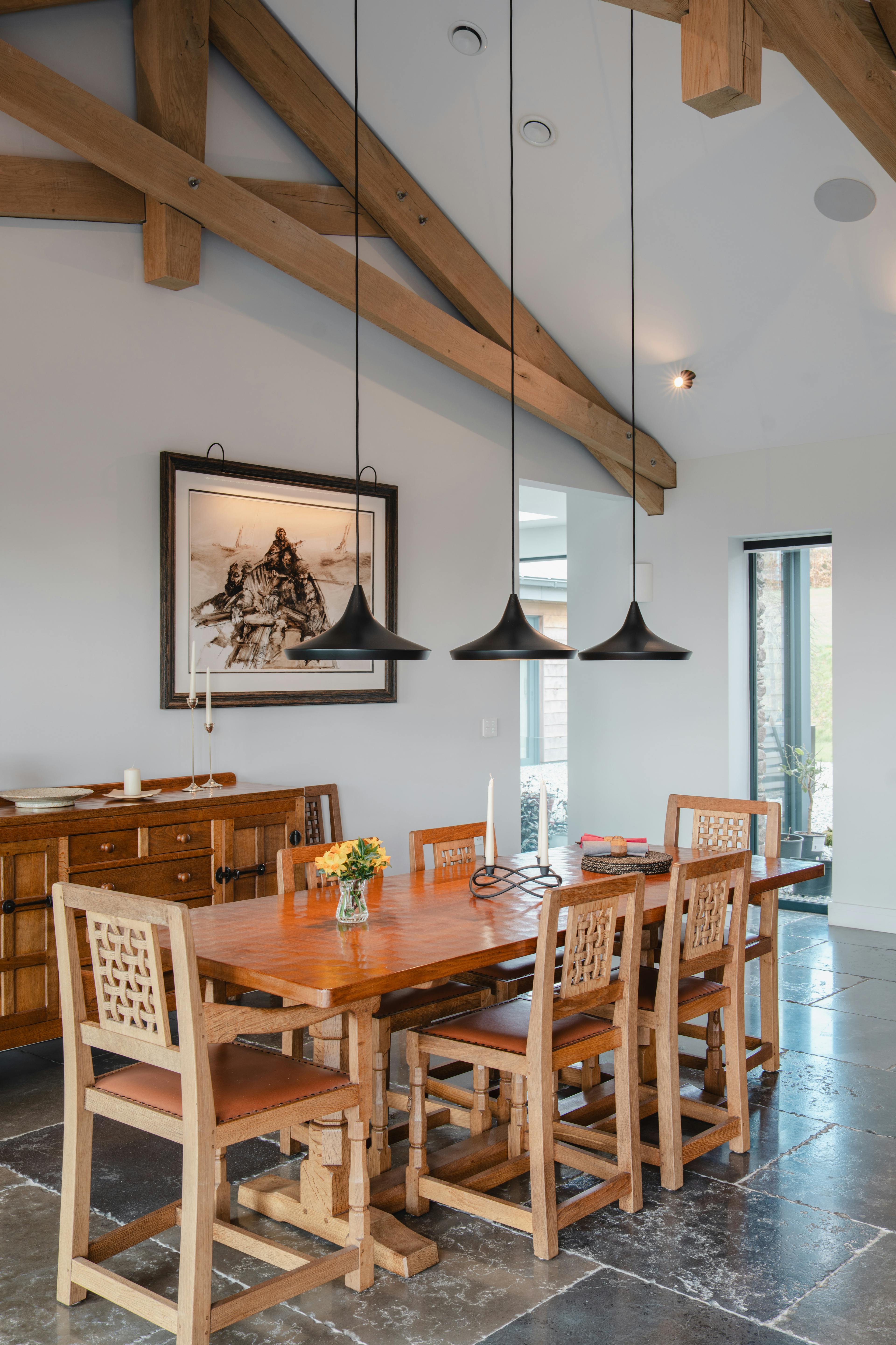 Dining room with oak trusses and pendant lighting