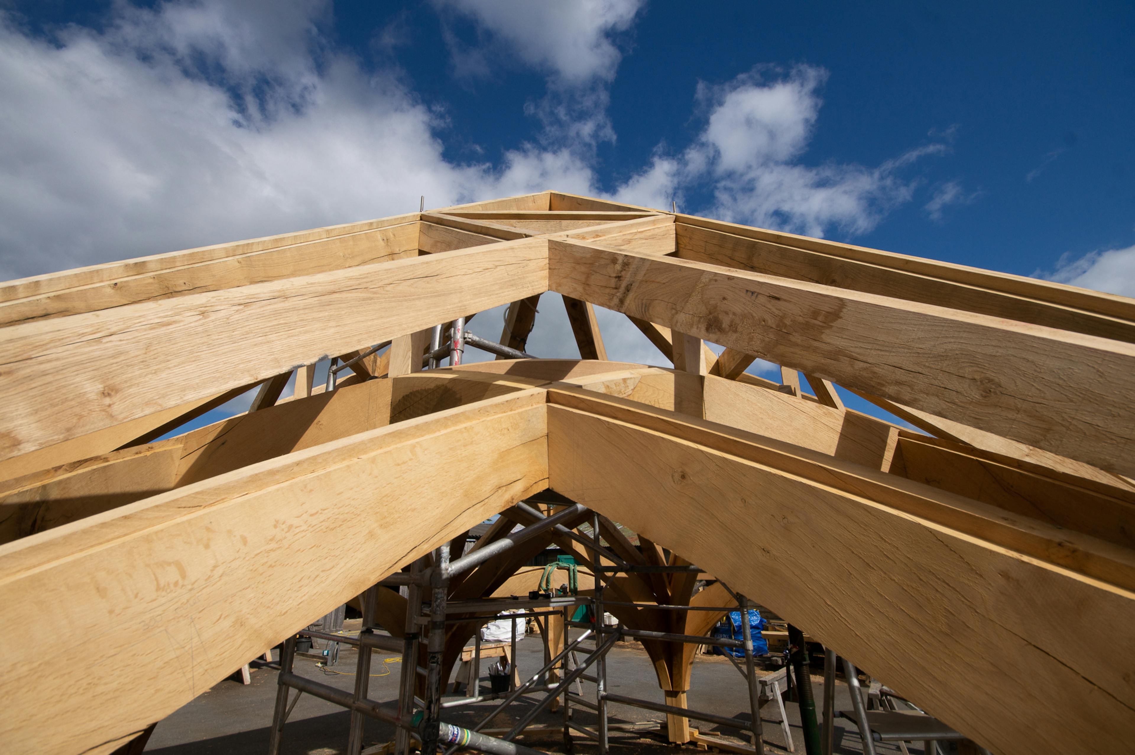 Timber frame rafters for Radley College being assembled in the Carpenter Oak workshop, designed by Purcell Architects, highlighting the structural layout and joinery