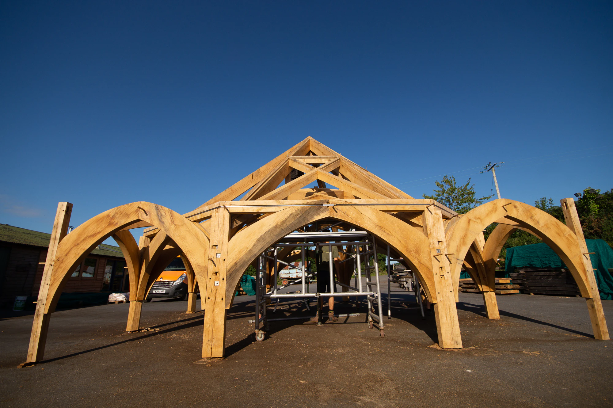 Finished timber frame for Radley College in the Carpenter Oak workshop, designed by Purcell Architects, showcasing precise joinery and craftsmanship