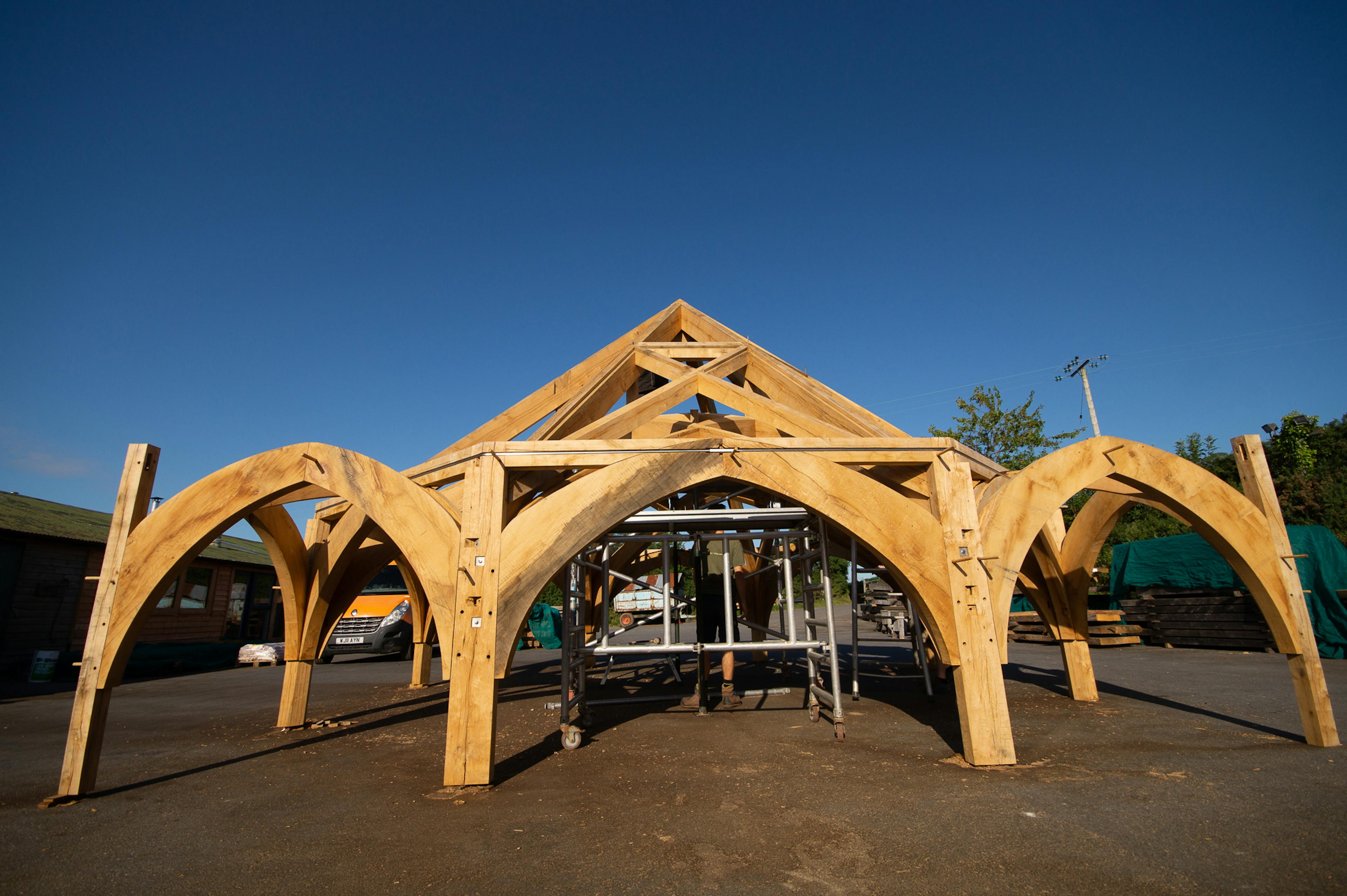 Finished timber frame for Radley College in the Carpenter Oak workshop, designed by Purcell Architects, showcasing precise joinery and craftsmanship