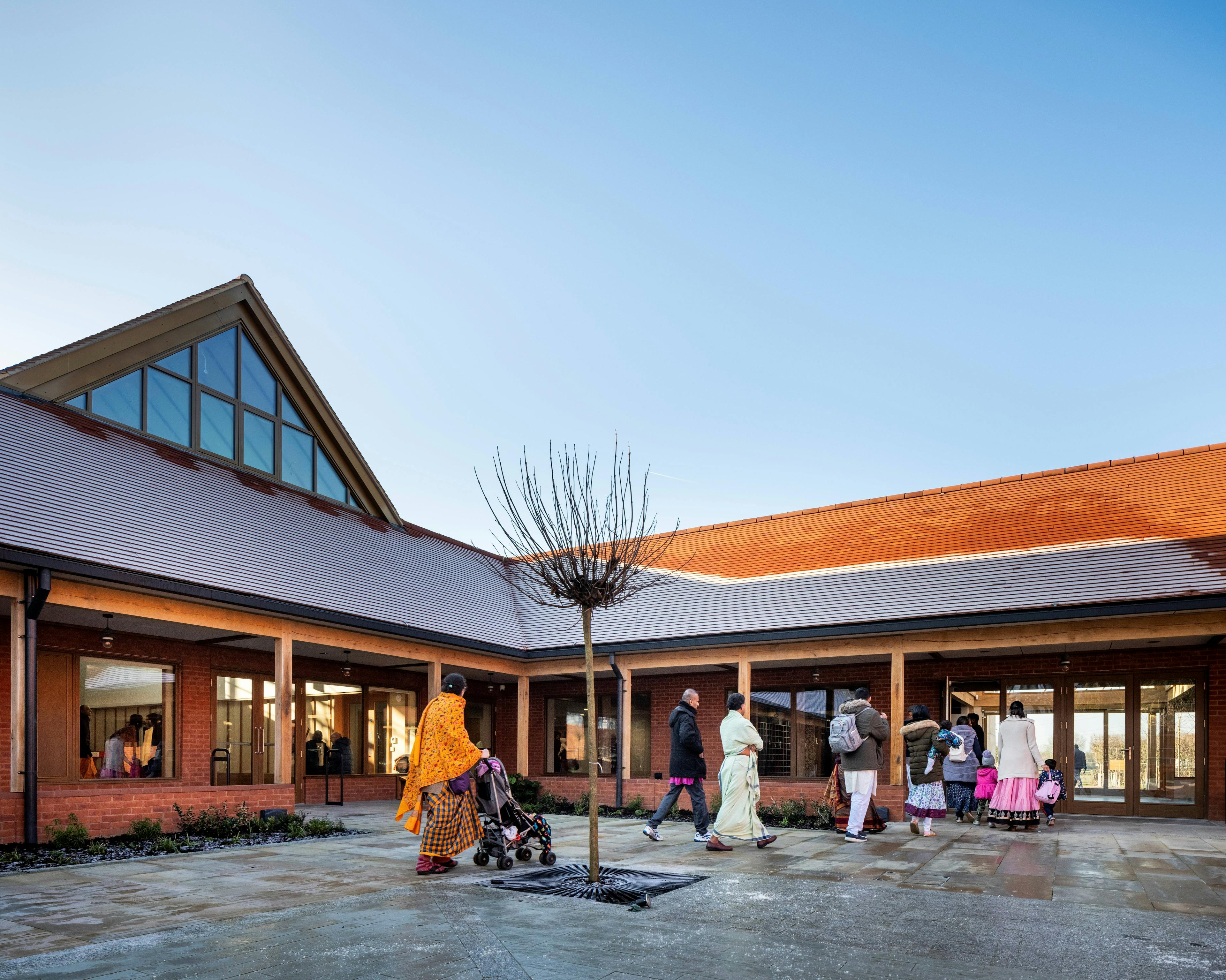 A courtyard of a Hindu Temple with green oak framed veranda