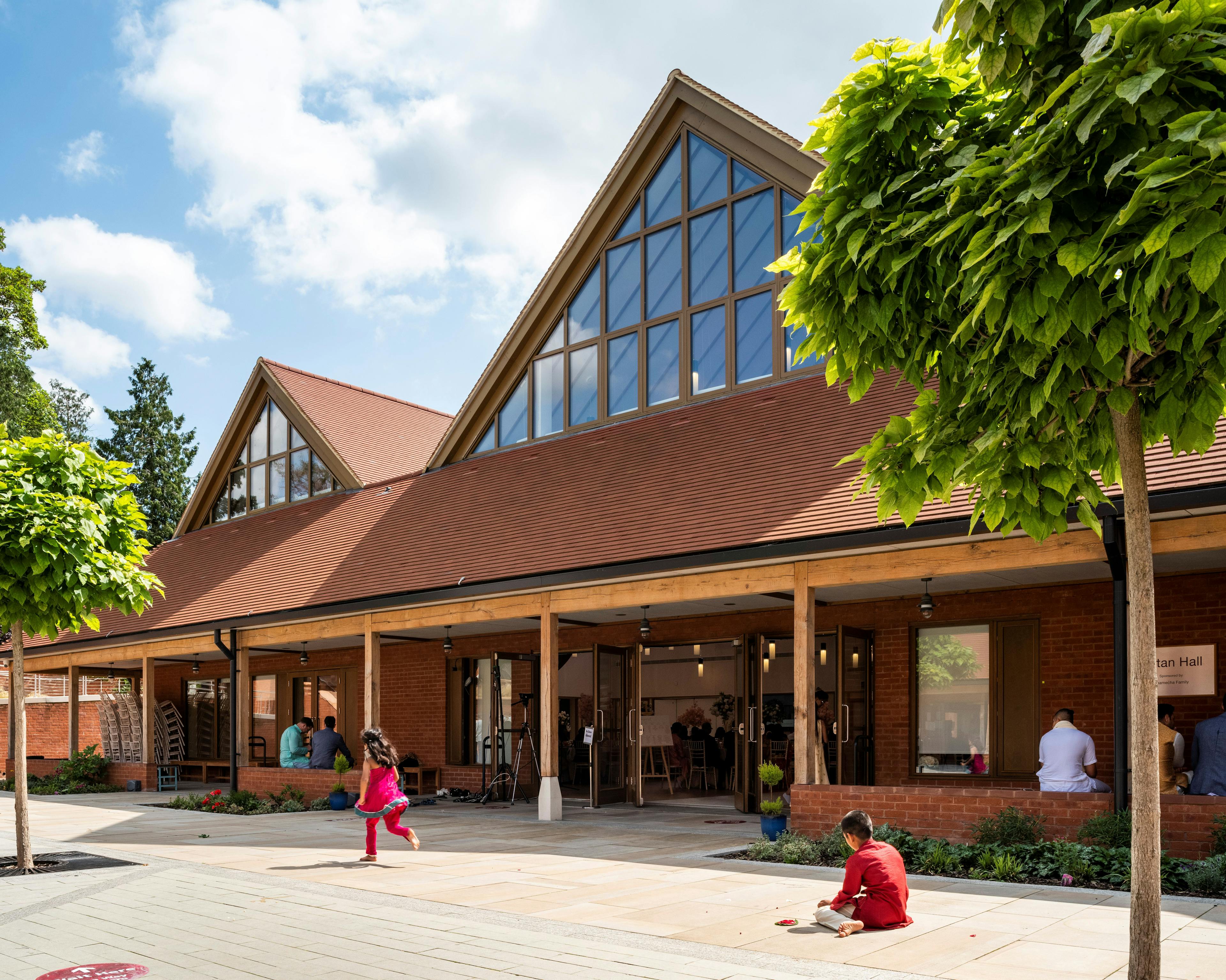 A  courtyard of a Hindu Temple with green oak framed veranda