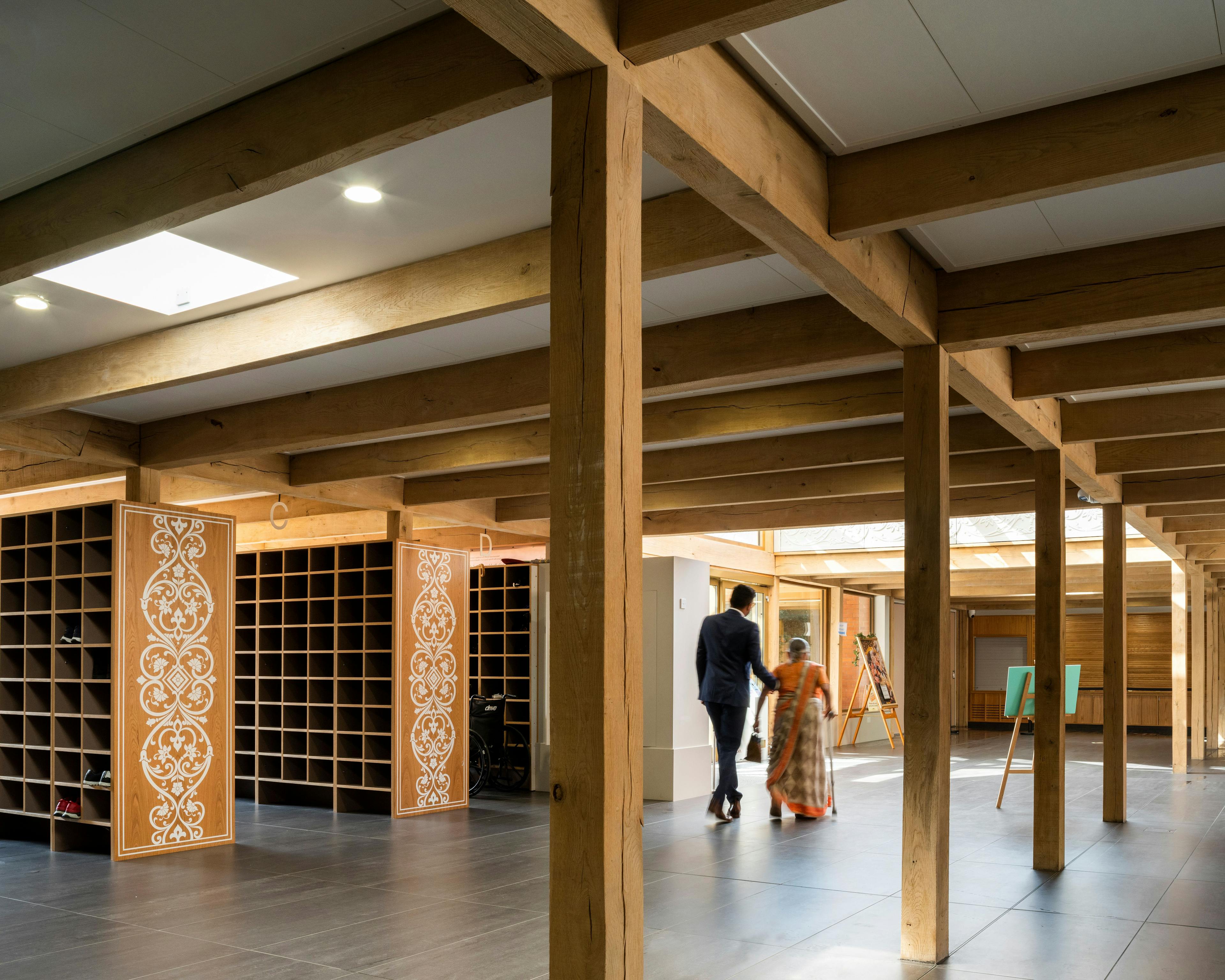 A green oak frame in side a Hindu Temple with pigeon hole cupboards for shoes
