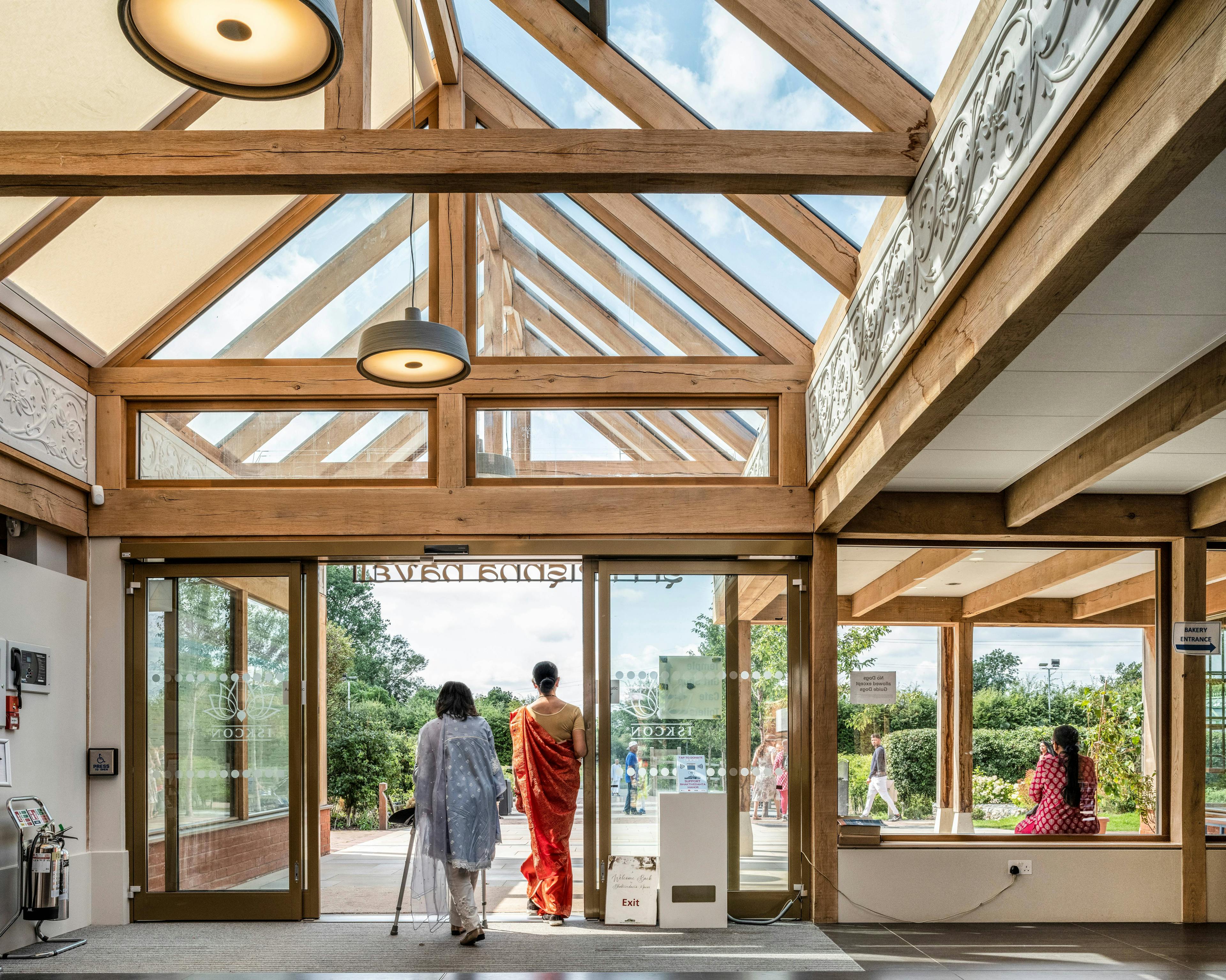 A green oak framed entranceway with a glazed vaulted ceiling of a Hindu Temple