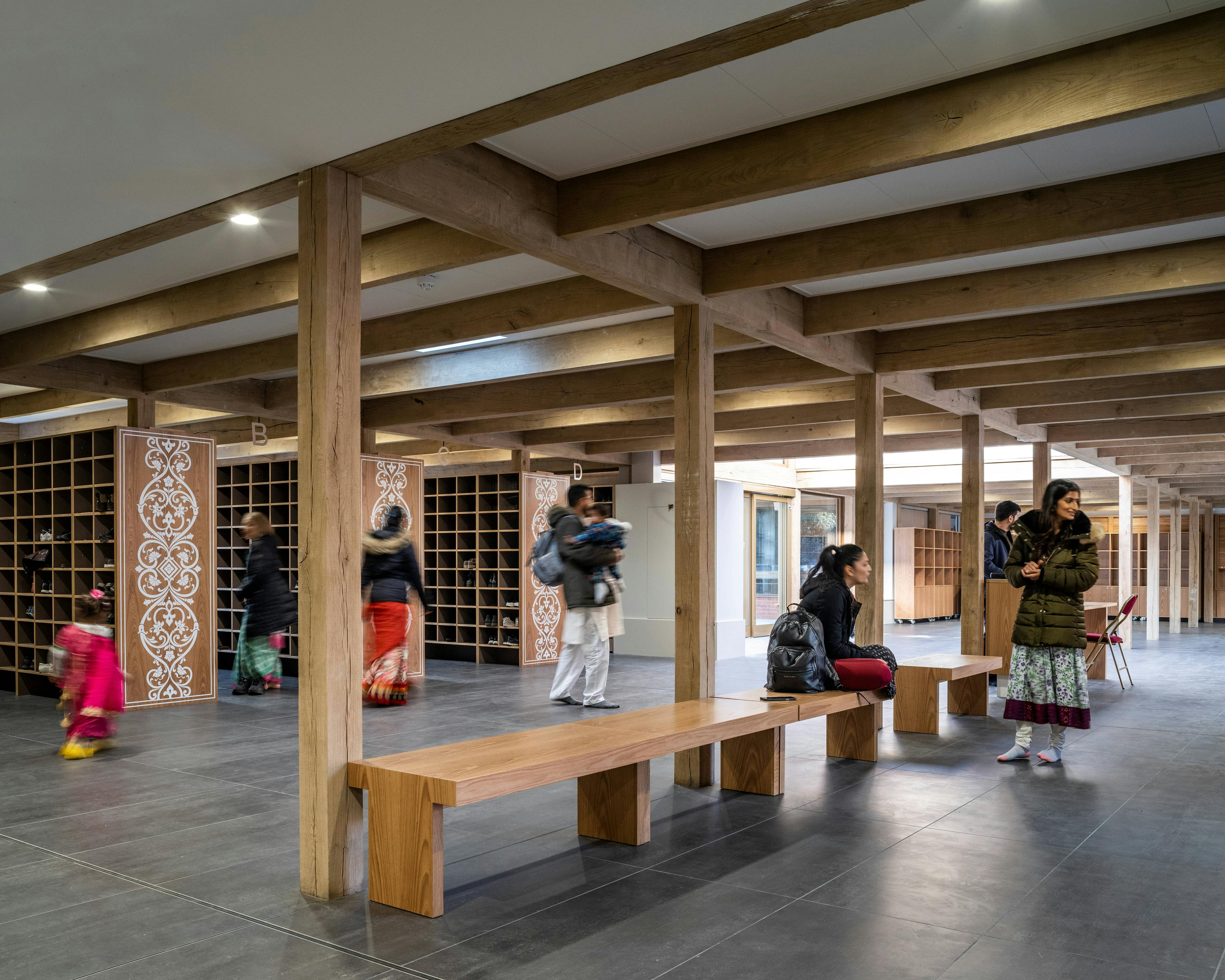 A green oak frame in side a Hindu Temple with pigeon hole cupboards for shoes and benches