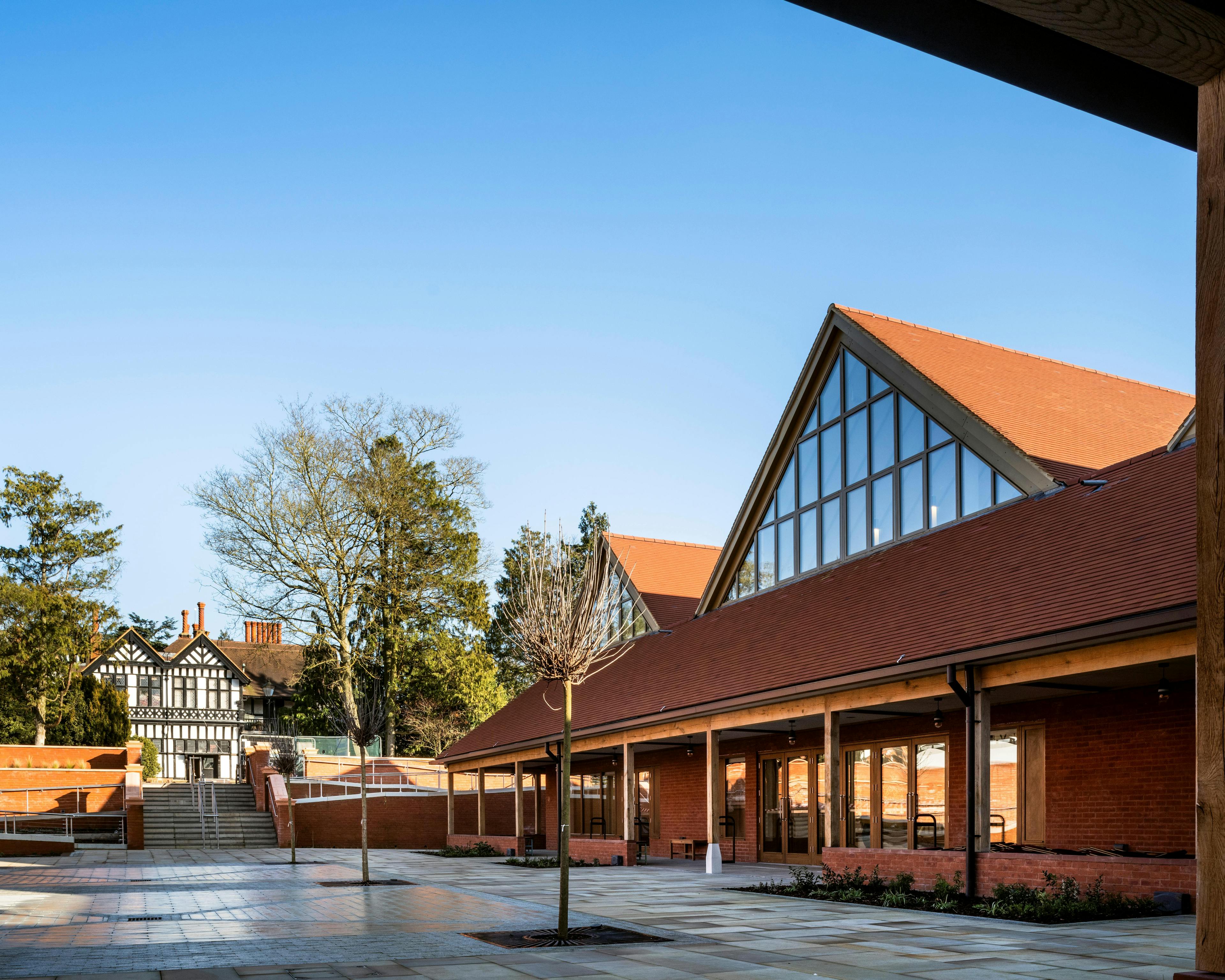 A courtyard of a Hindu Temple with green oak framed veranda