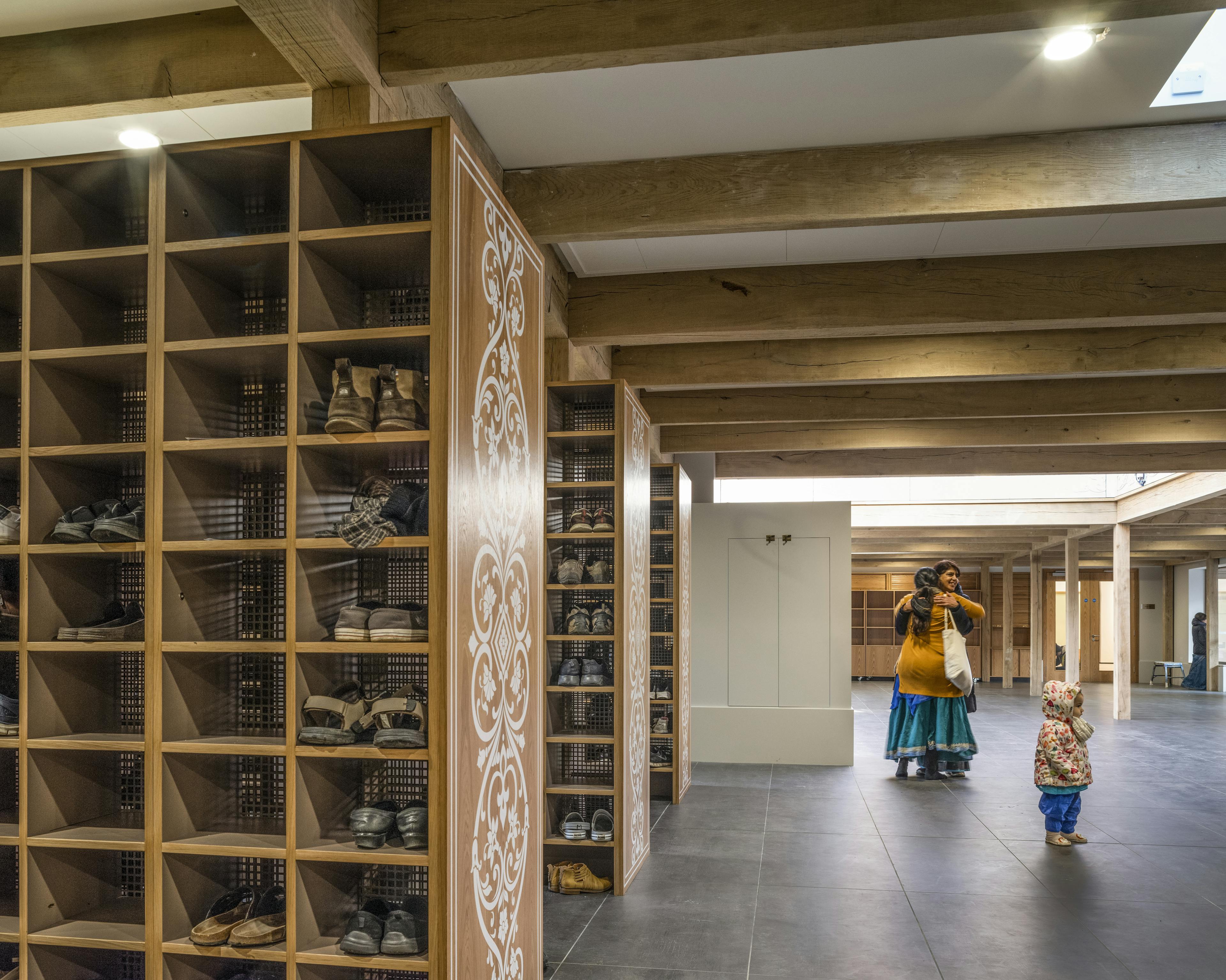 A green oak frame in side a Hindu Temple with pigeon hole cupboards for shoes
