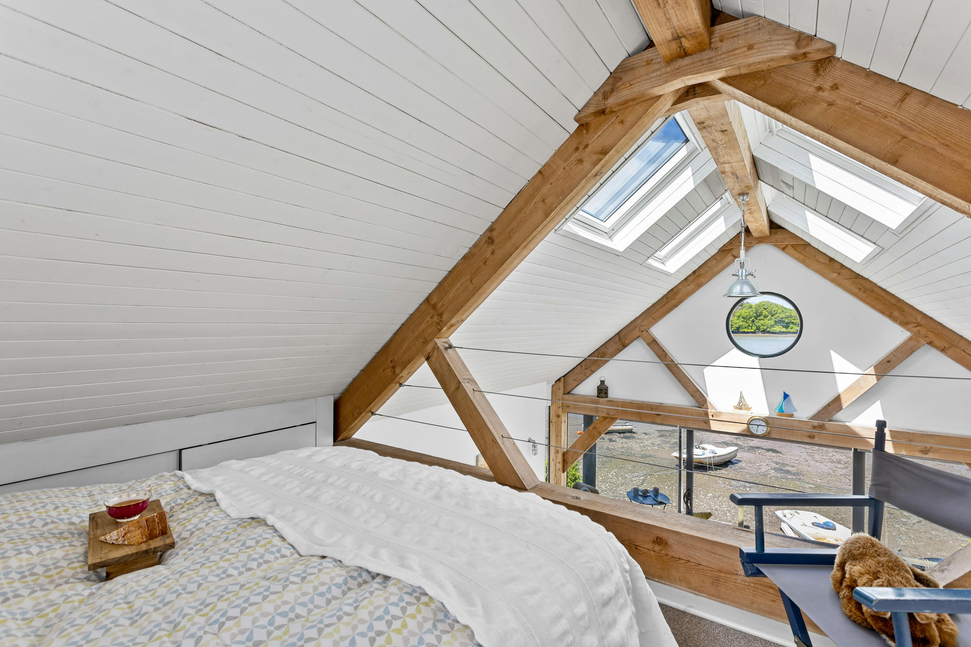 The mezzanine bedroom of an oak framed boathouse