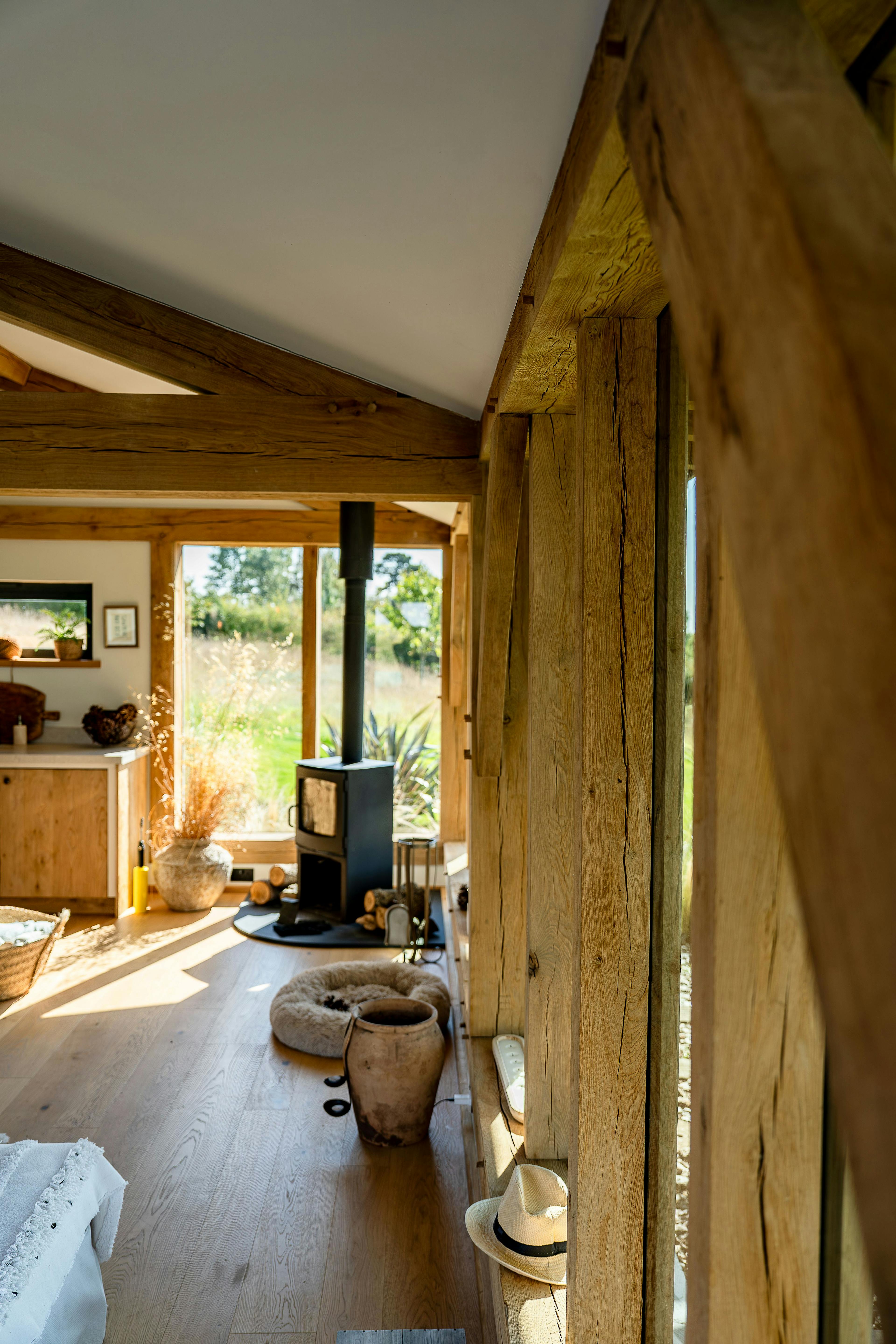 Inside an oak framed pool building annexe with a log burner