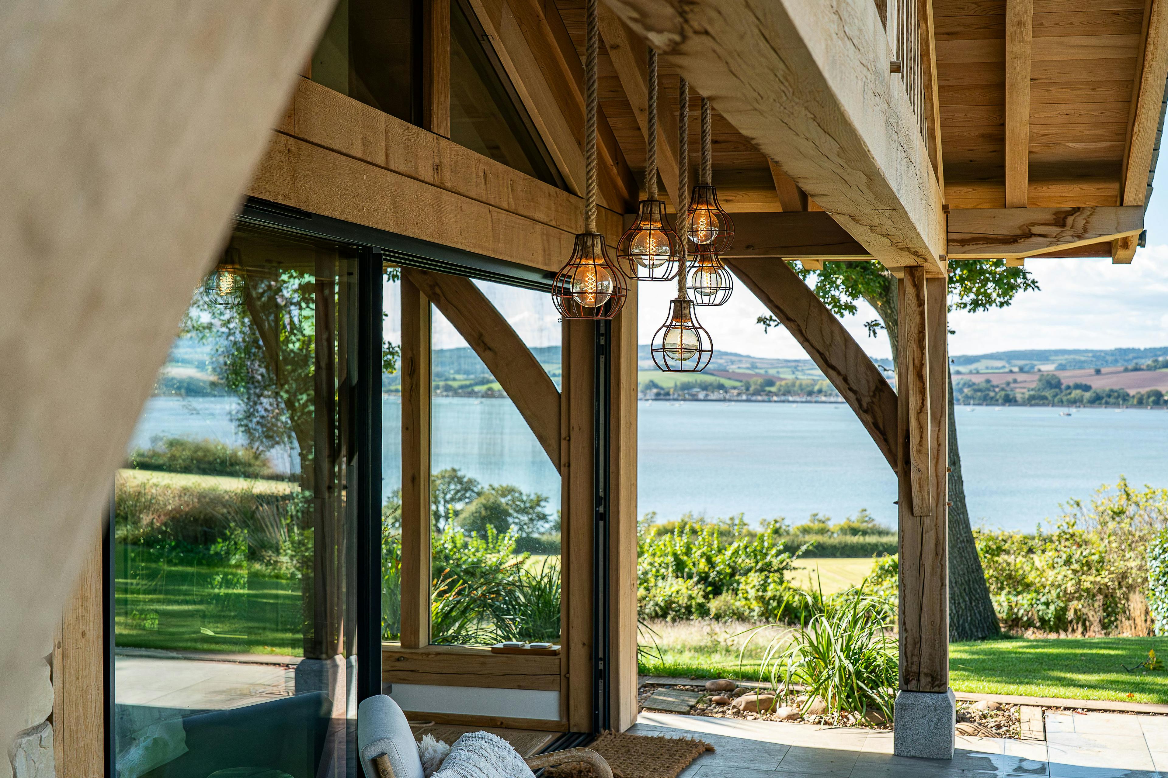 The veranda of an oak framed pool building annexe in a large garden with views of the River Exe