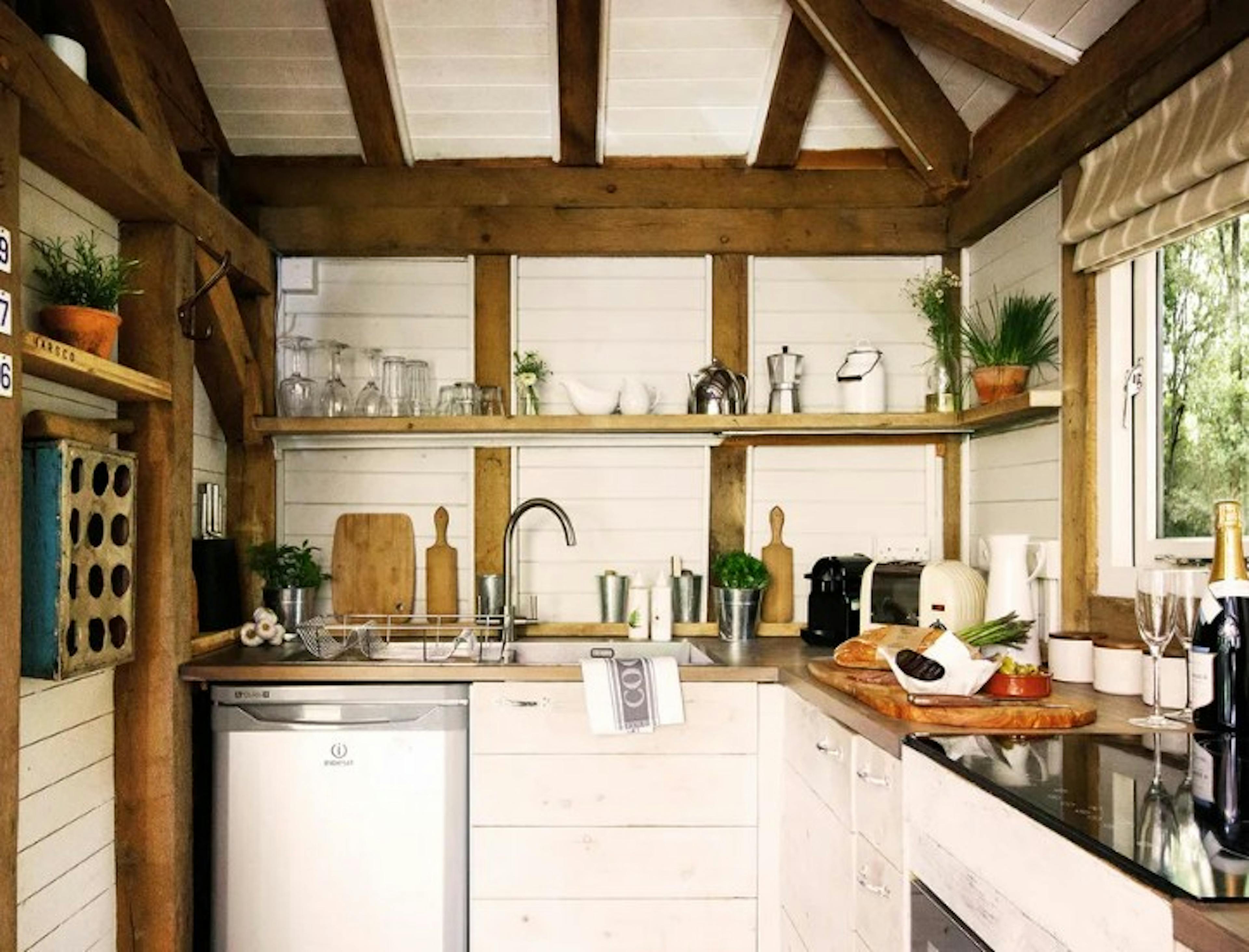The kitchen in an open plan oak framed cabin