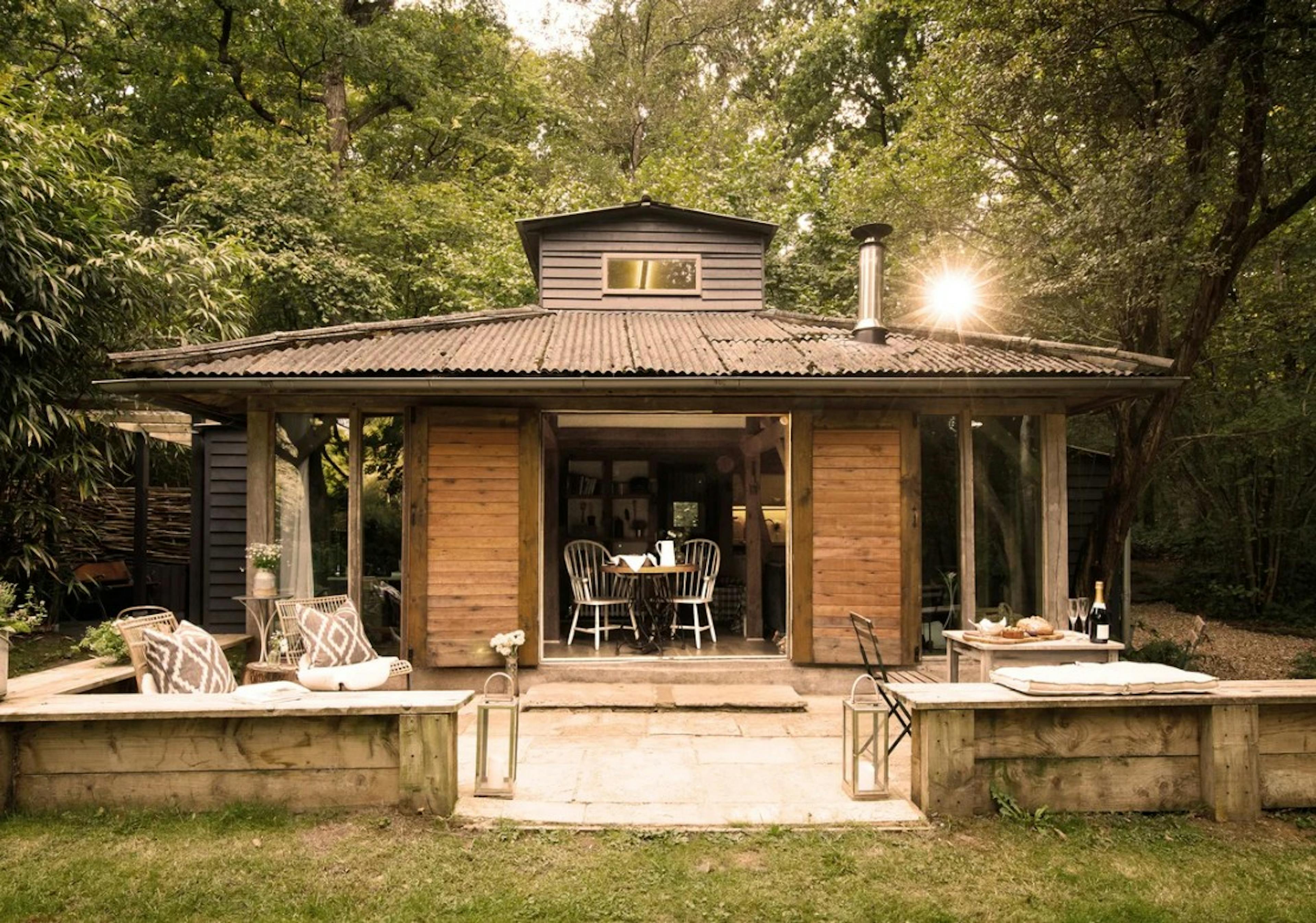 Outside of an oak framed cabin with decking and outdoor furniture