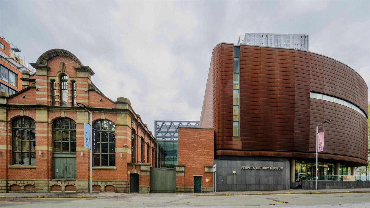Exterior view of the People’s History Museum building, showing its modern glass and steel architecture beside the river.