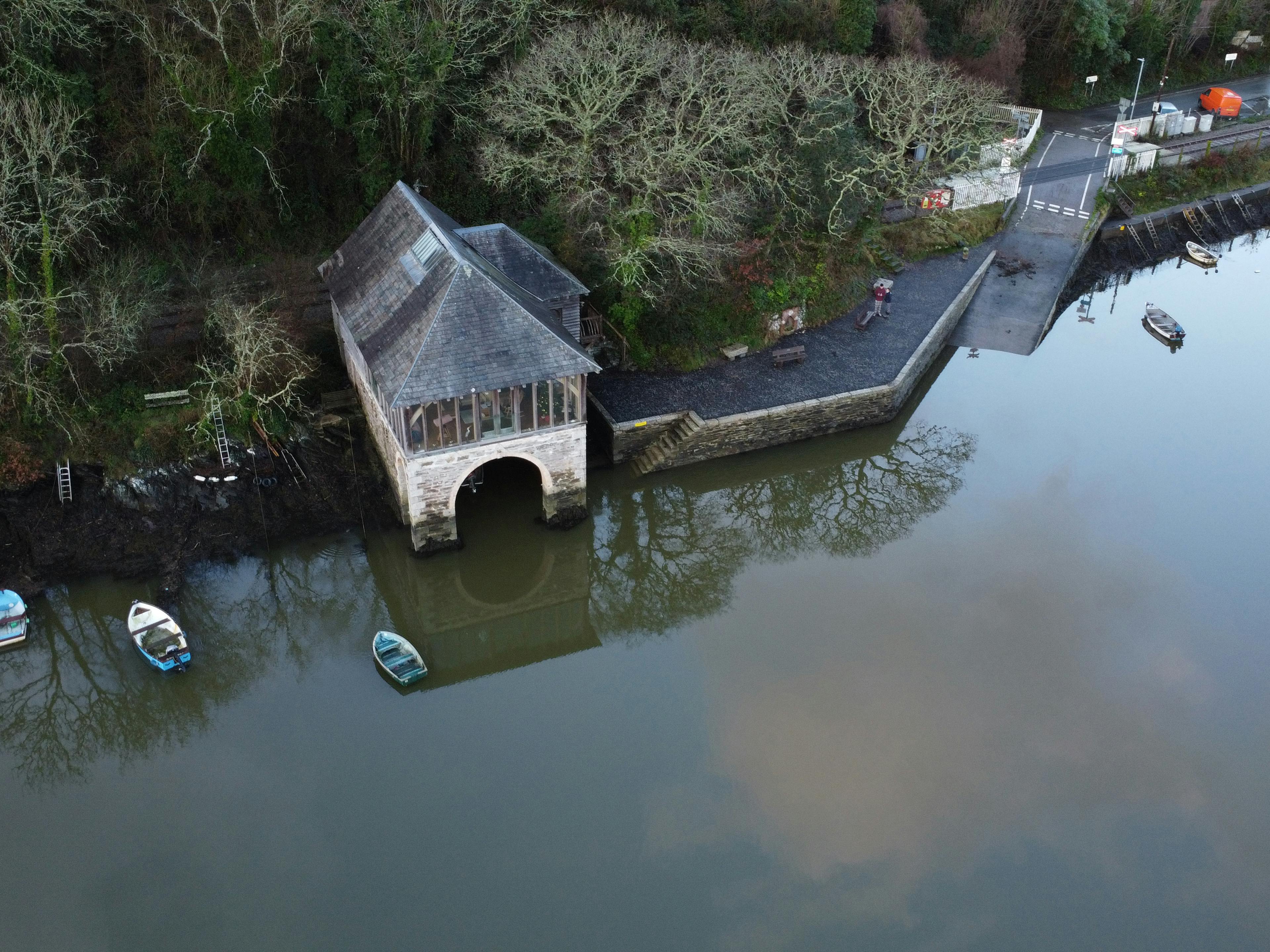 Ariel view of an oak framed retreat on top of a stone boathouse on the River Fowey 
