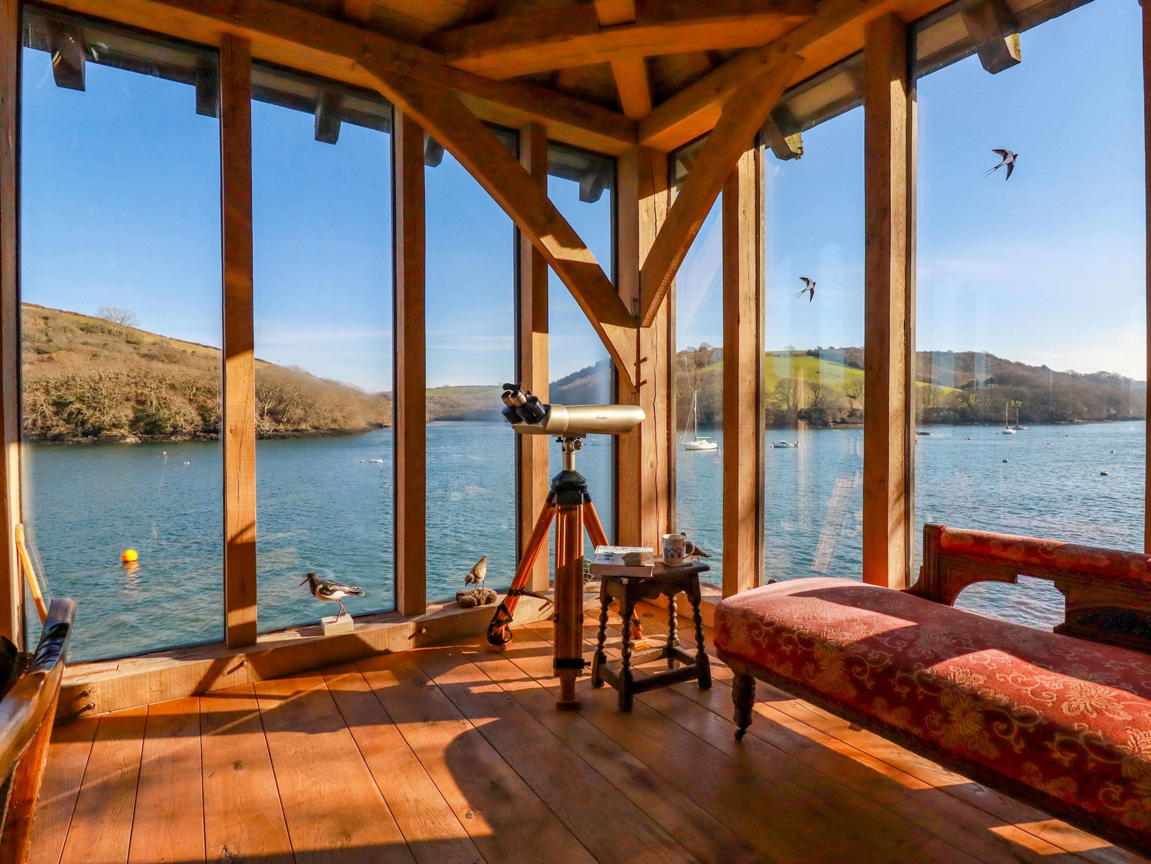 Glazed windows provide views of the River Fowey from an oak framed boathouse 