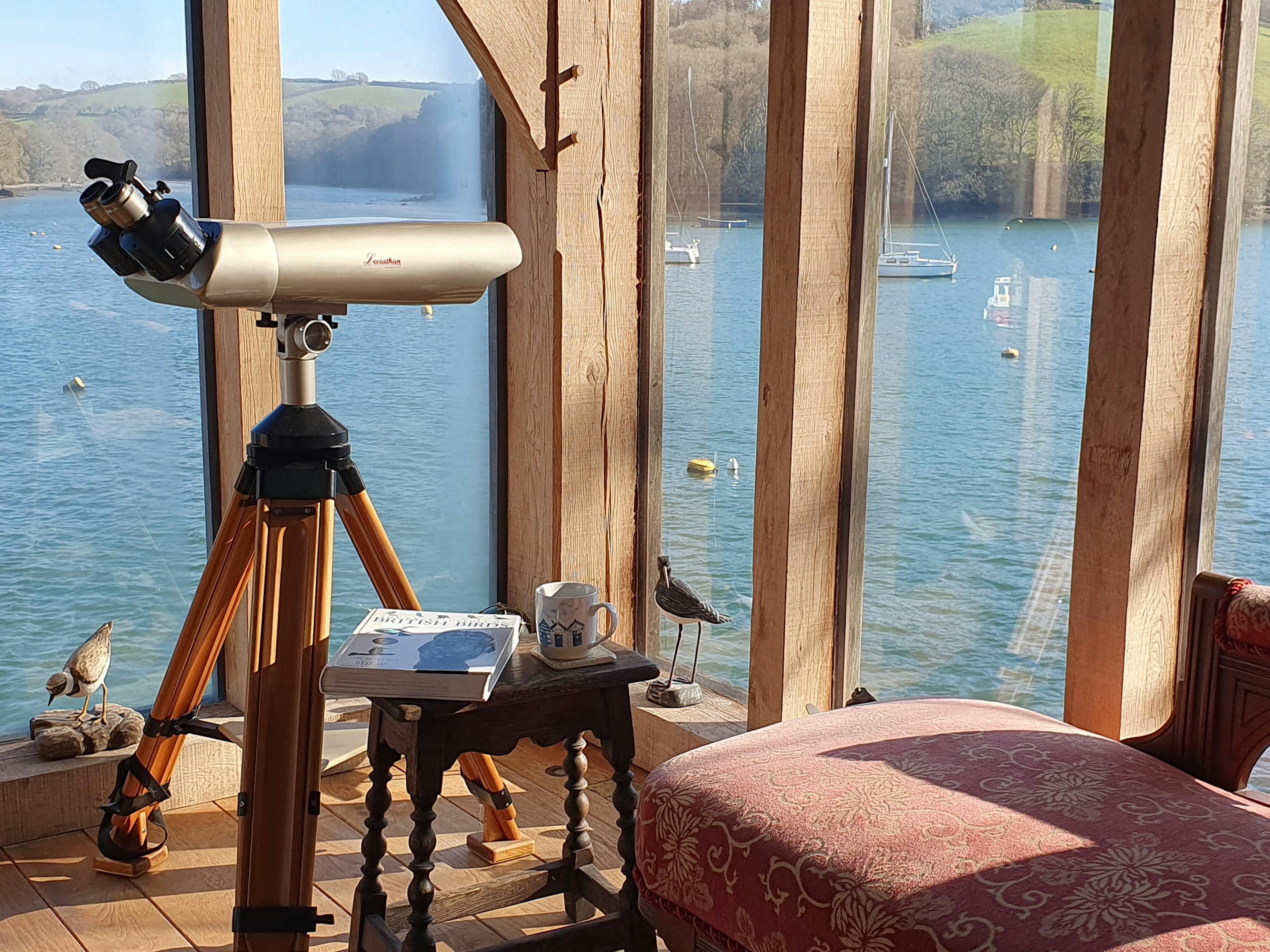 Glazed windows provide views of the River Fowey from an oak framed boathouse 