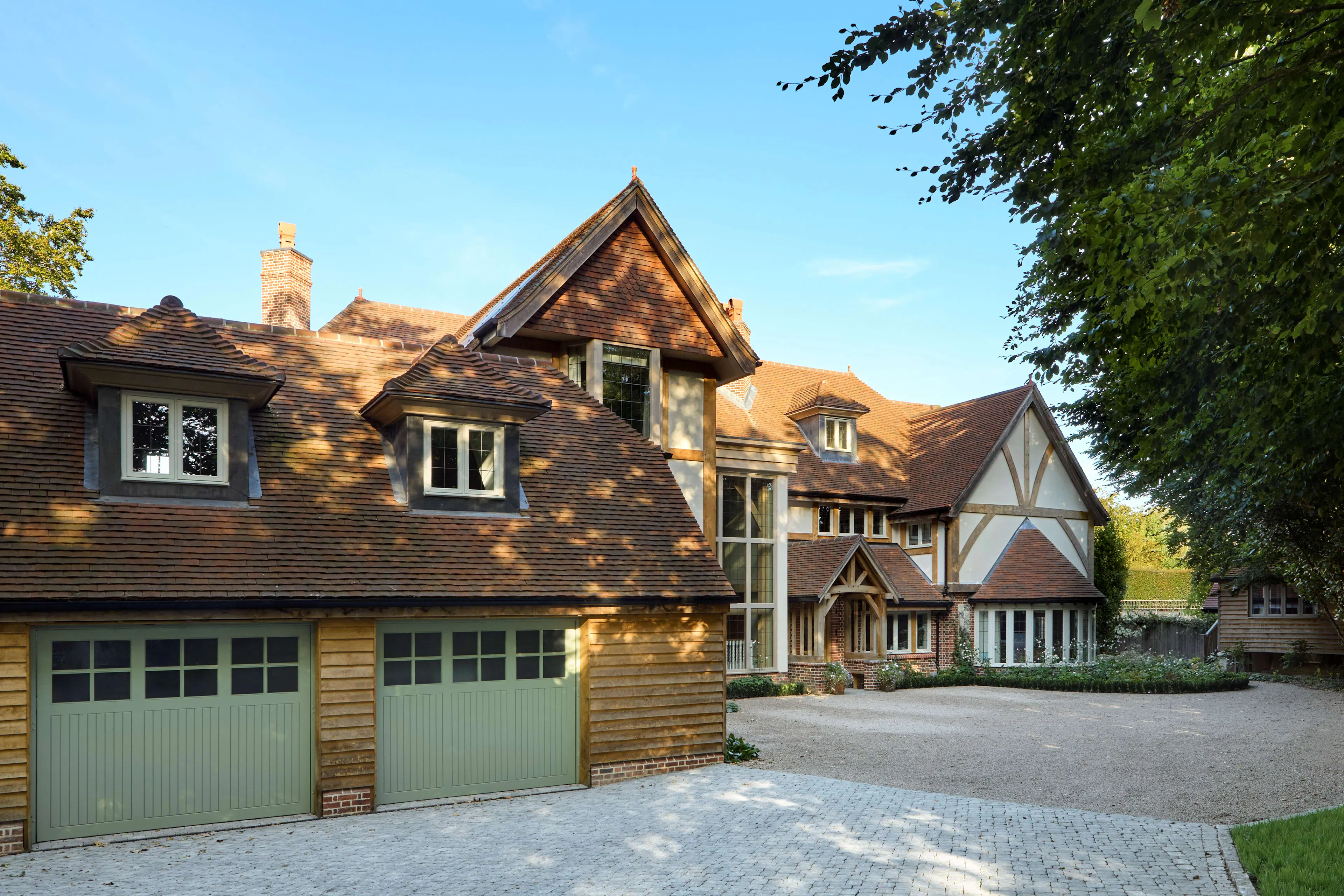 The front of a large 6 bedroom oak framed home with a double garage