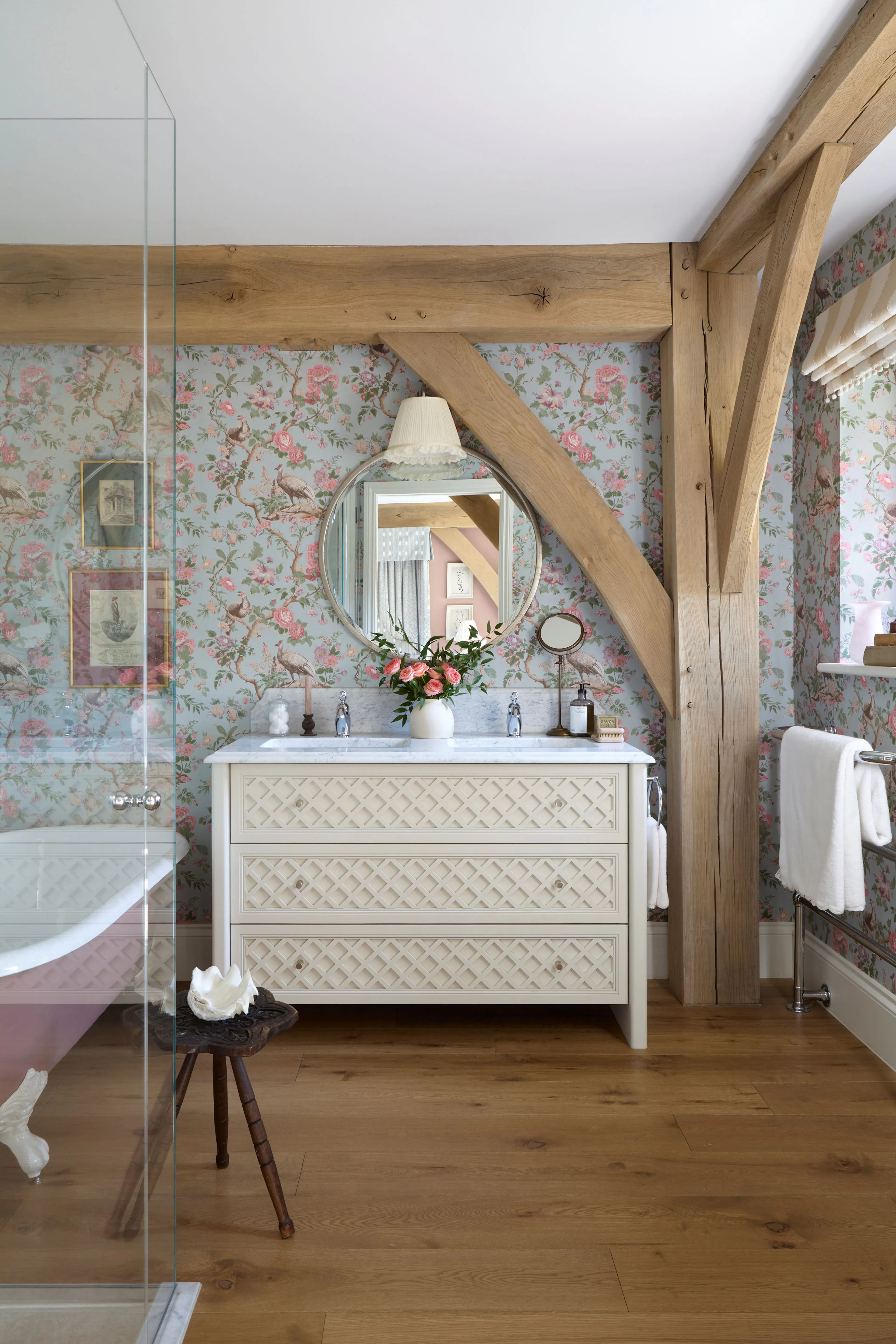 A bathroom with a pink freestanding bath in a large 6 bedroom oak framed home