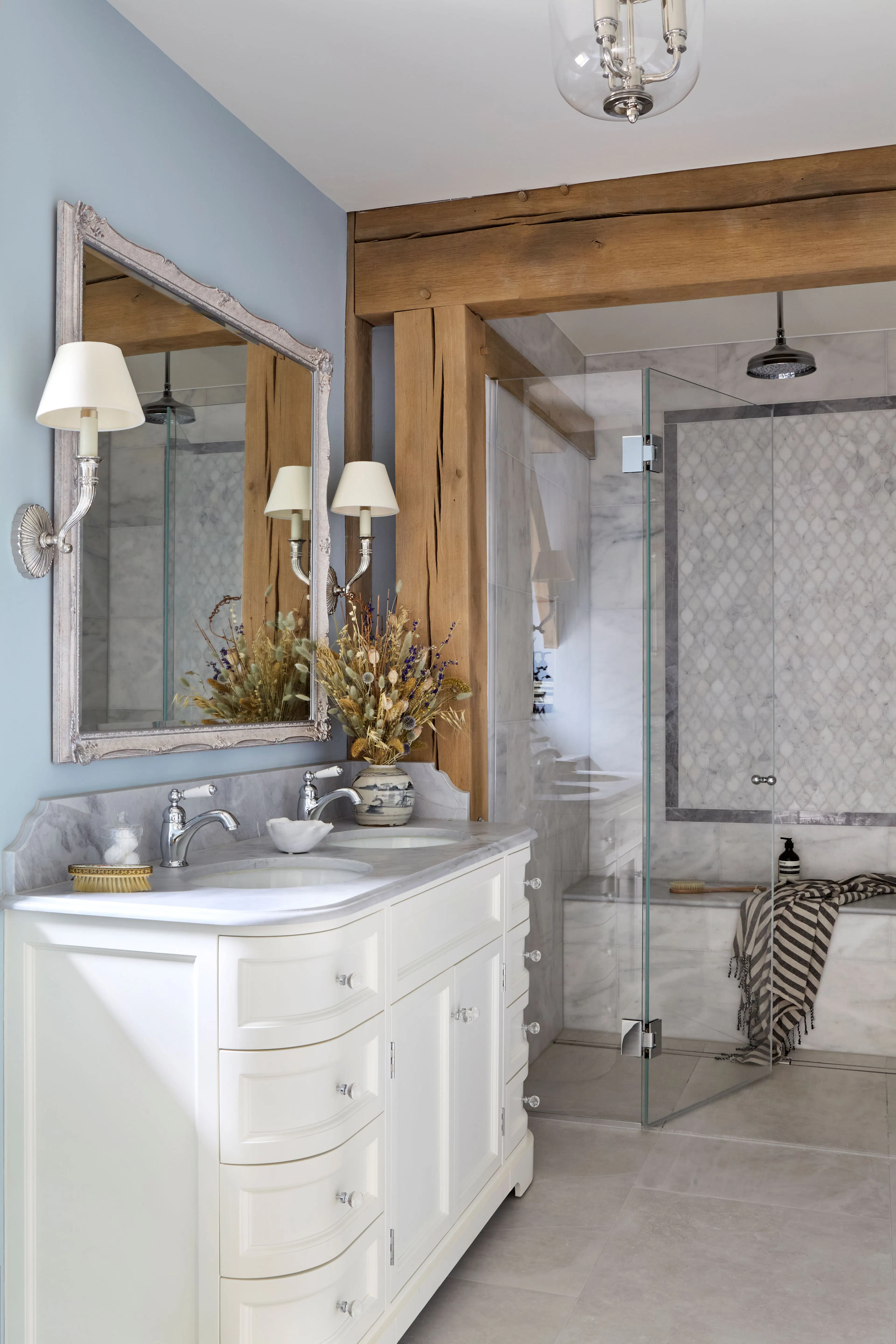 A bathroom with walk in shower in a large 6 bedroom oak framed home