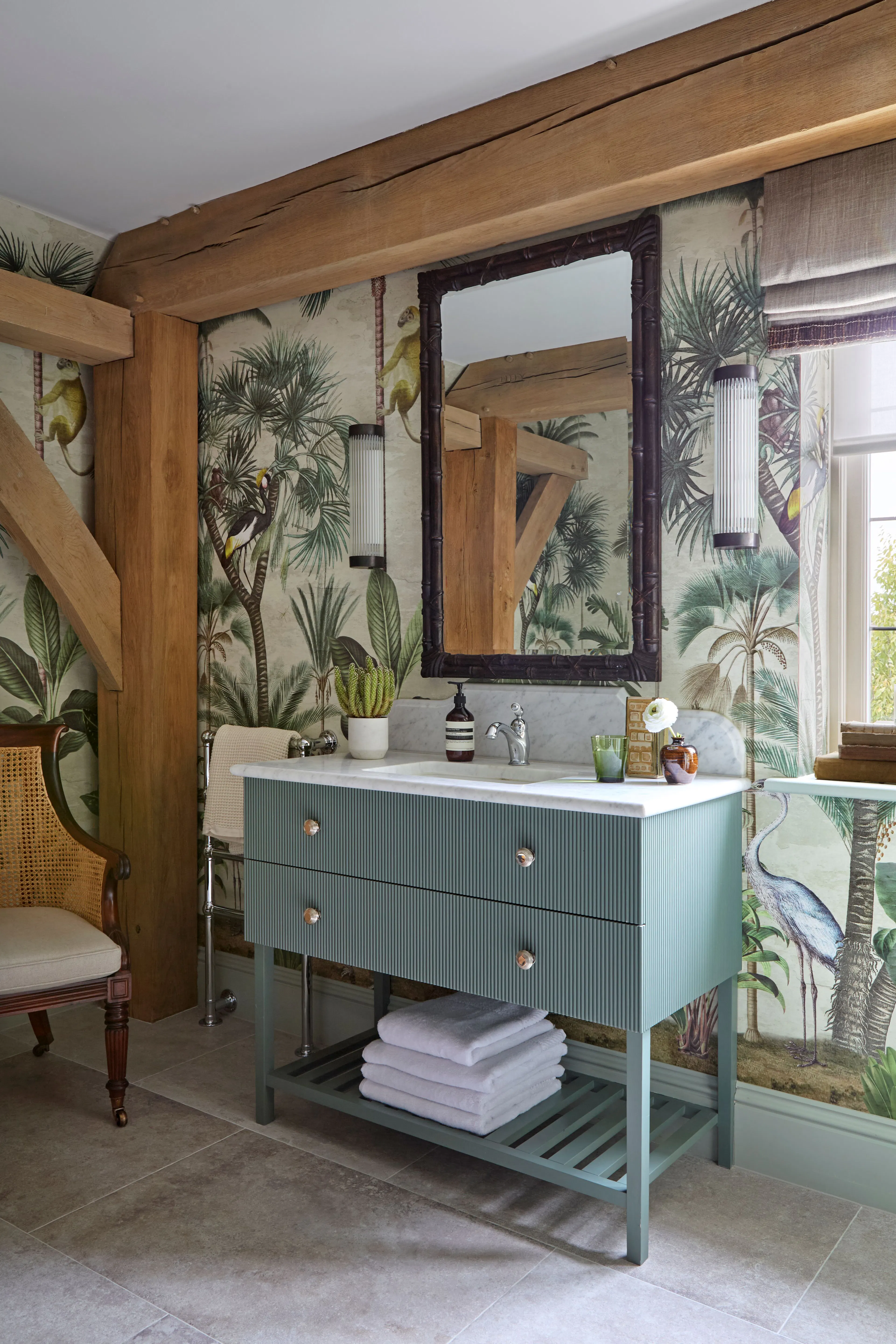 A bathroom with blue vanity unit in a large 6 bedroom oak framed home
