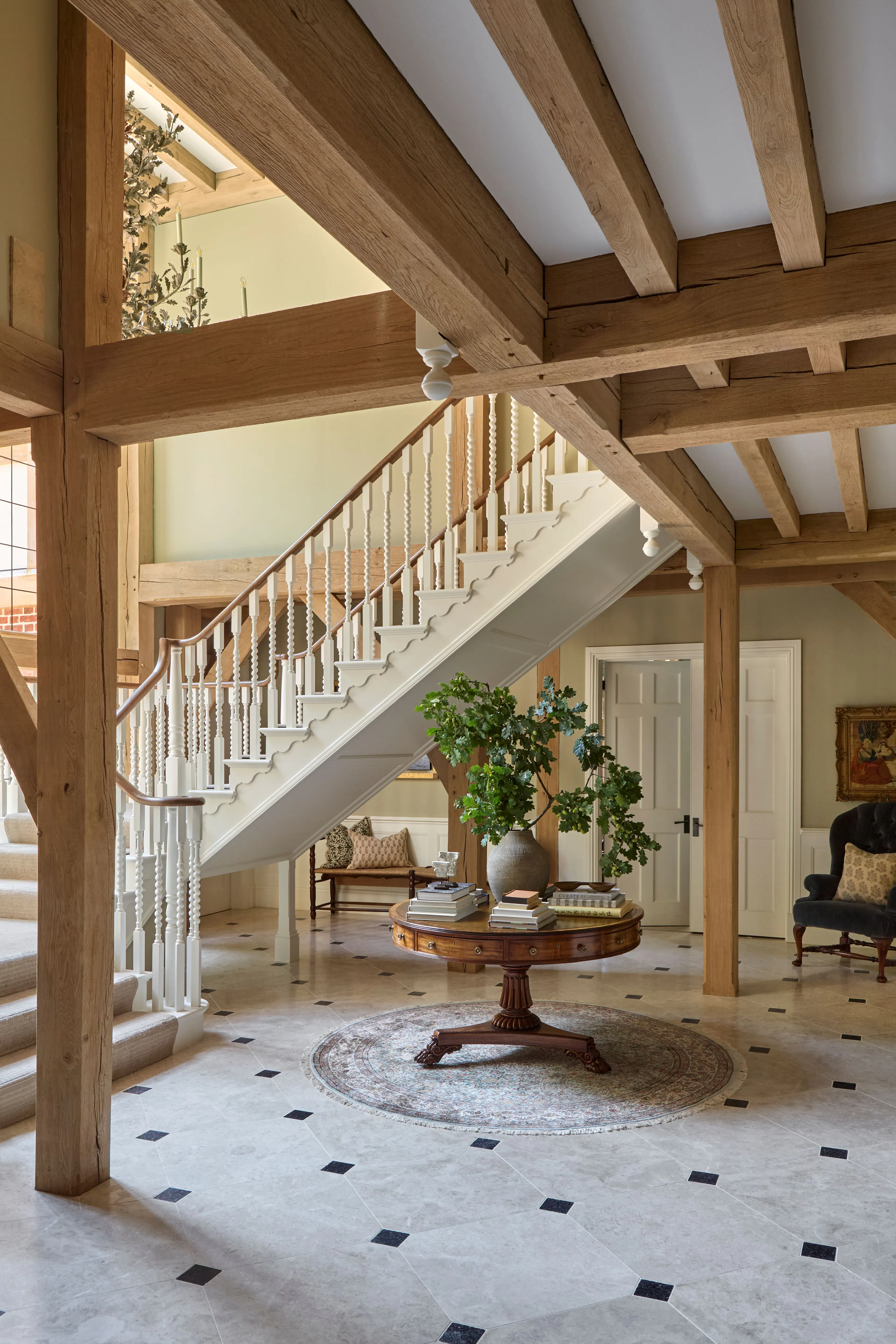 The stairway with double height glazing in a large 6 bedroom oak framed home