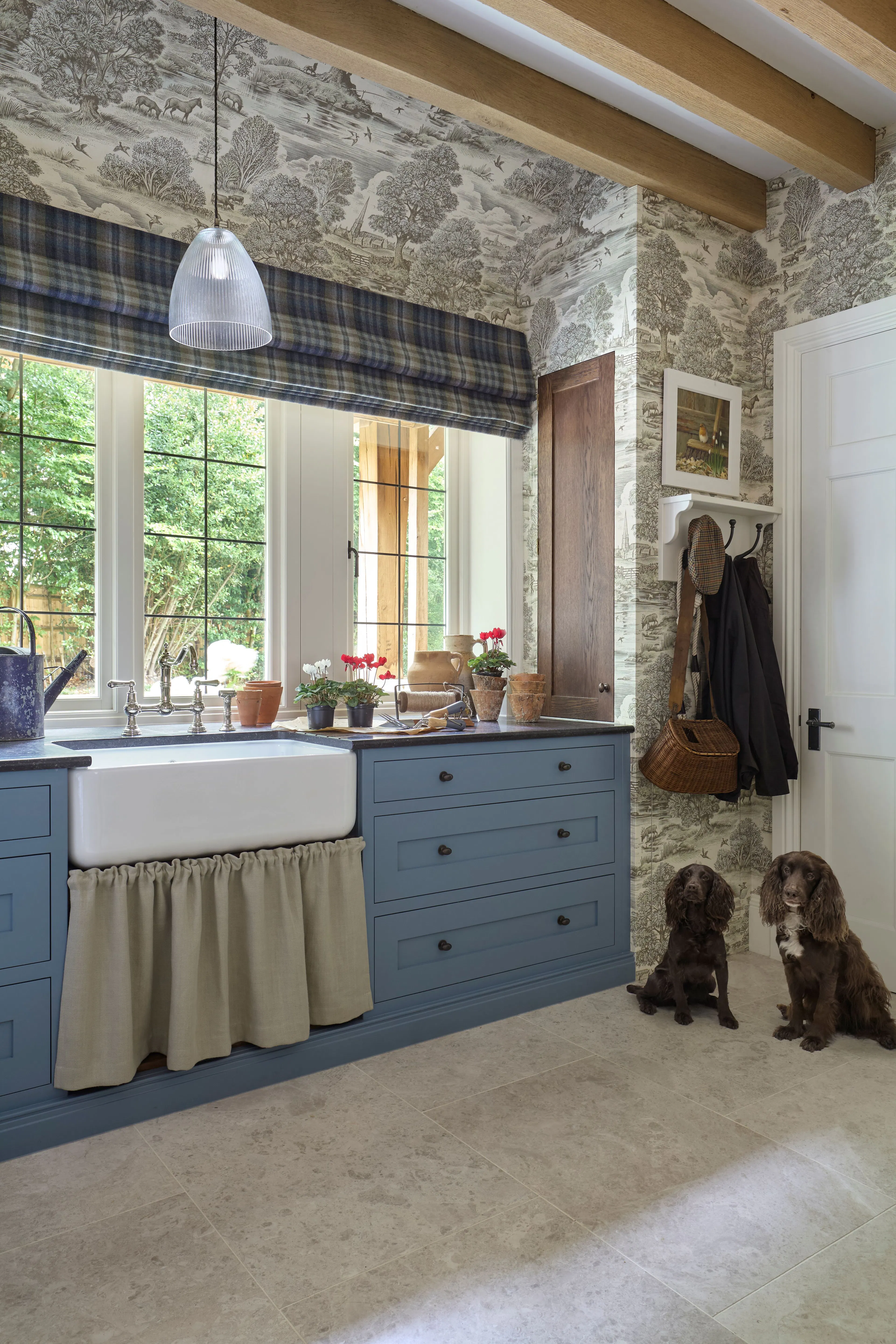 A boot room with built in cupboards and a dog bed in a large 6 bedroom oak framed home