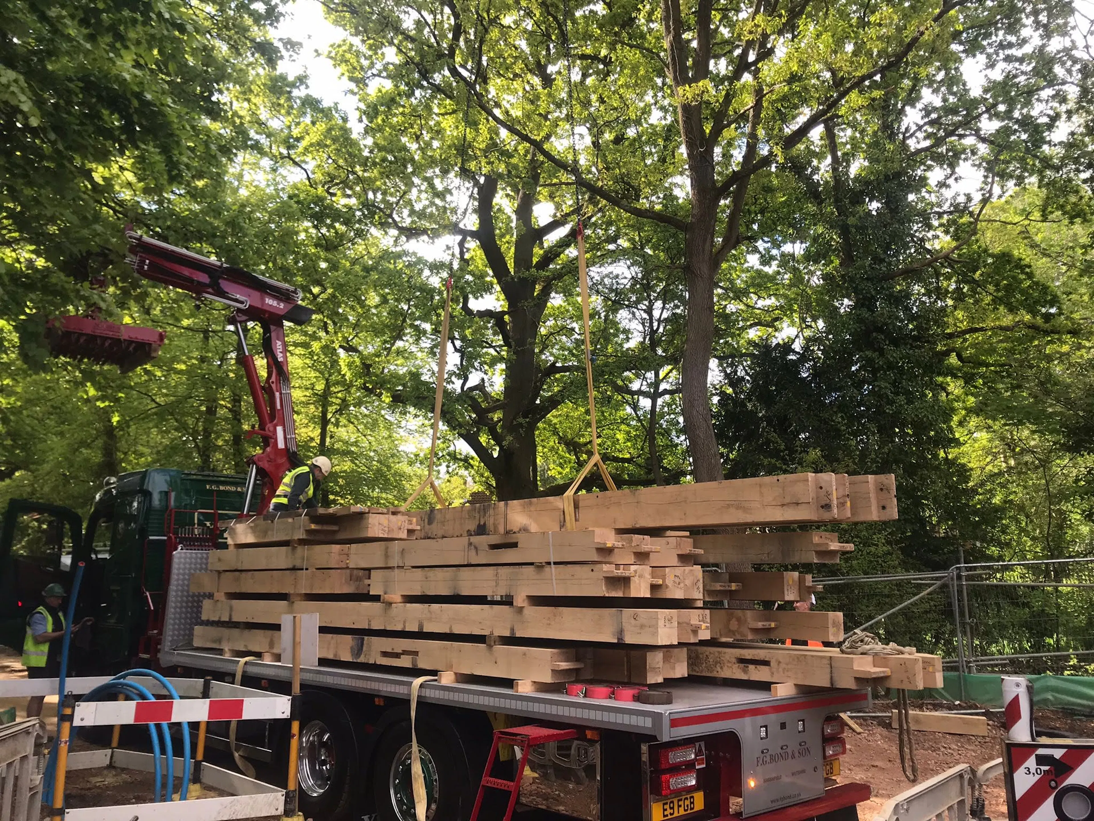 A lorry delivers some of the oak frame during installation of a large 6 bedroom oak framed family home
