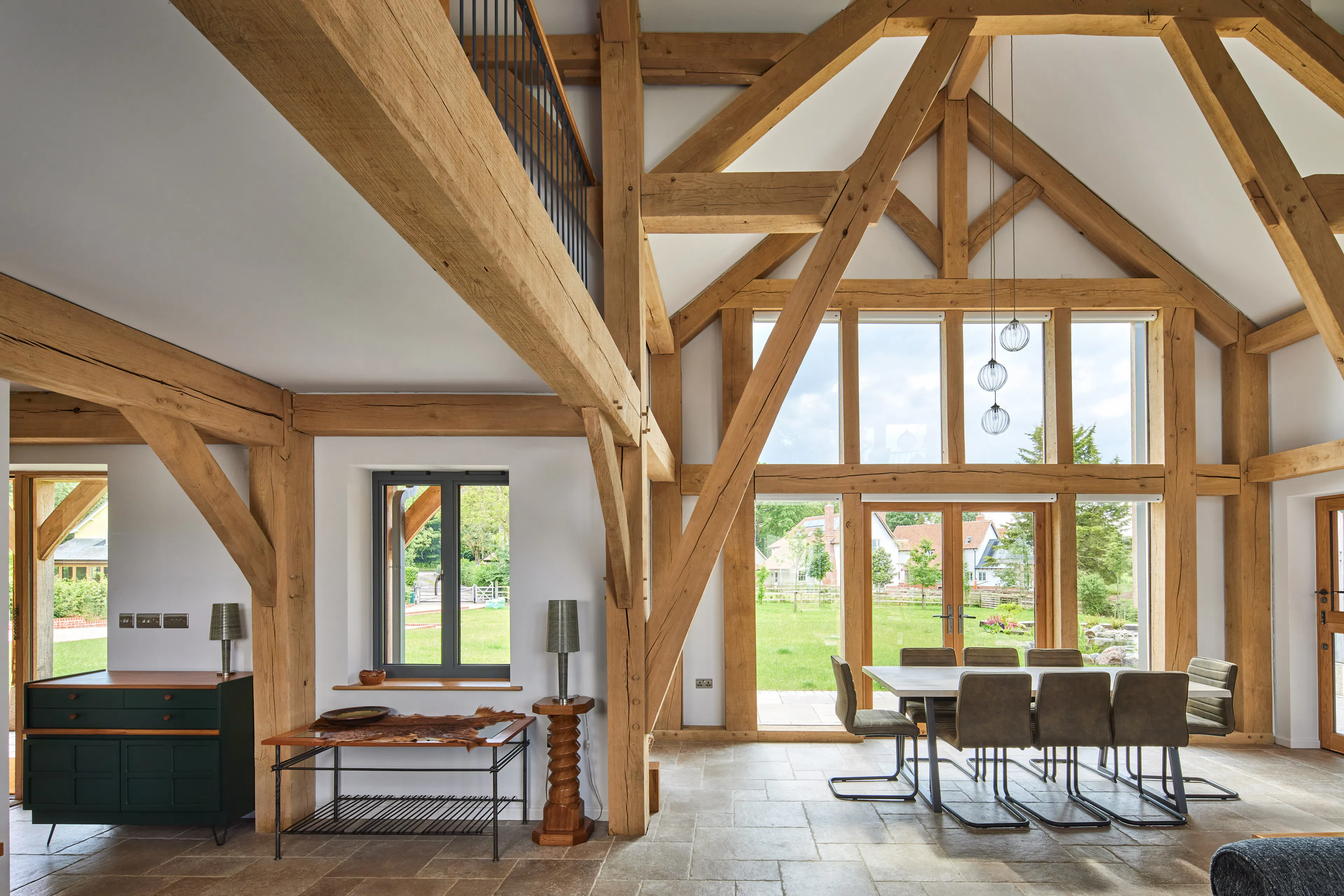 The entrance and dining area in the downstairs open plan area of a large oak framed home