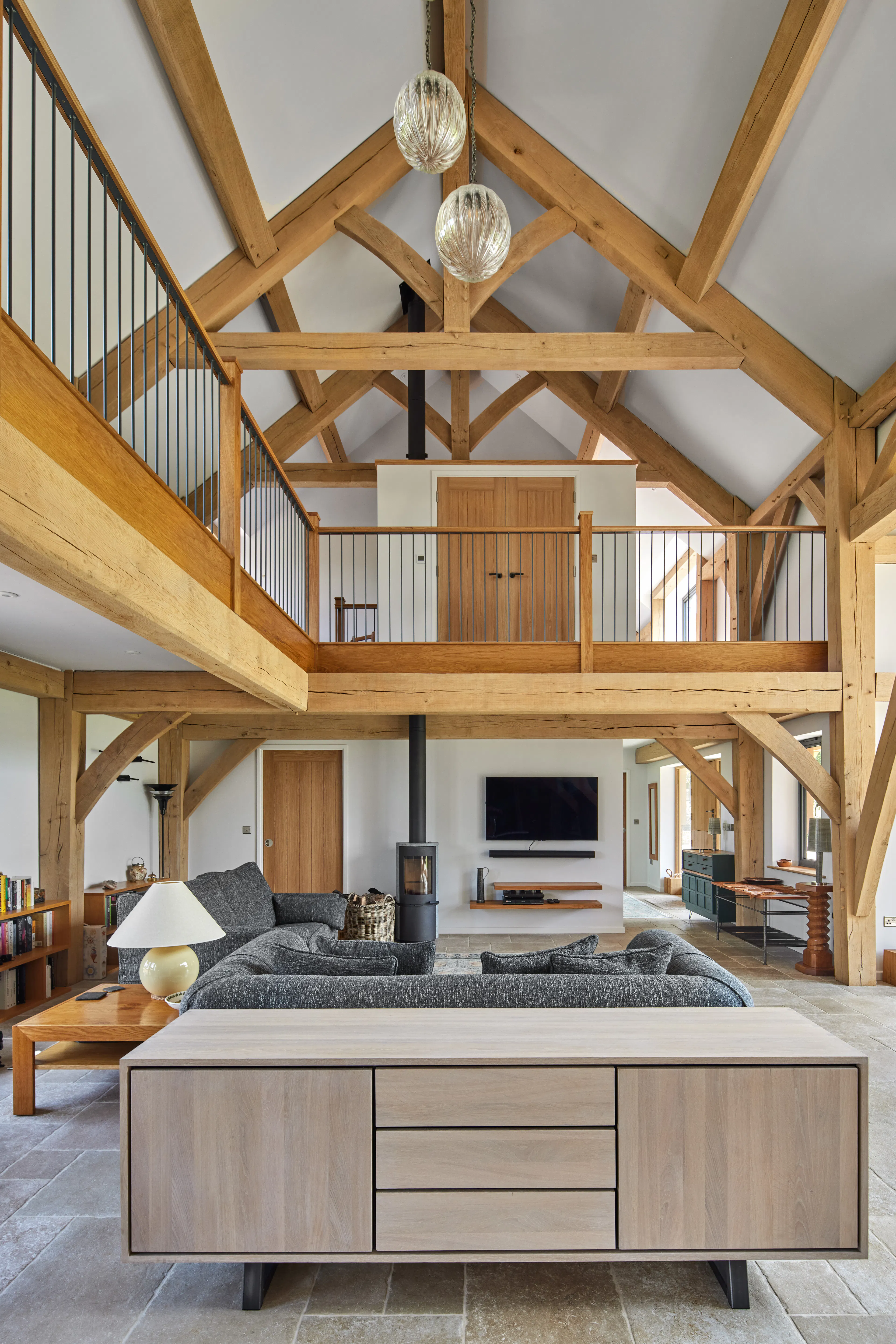 The sitting area and log burner in the downstairs open plan area of a large oak framed home