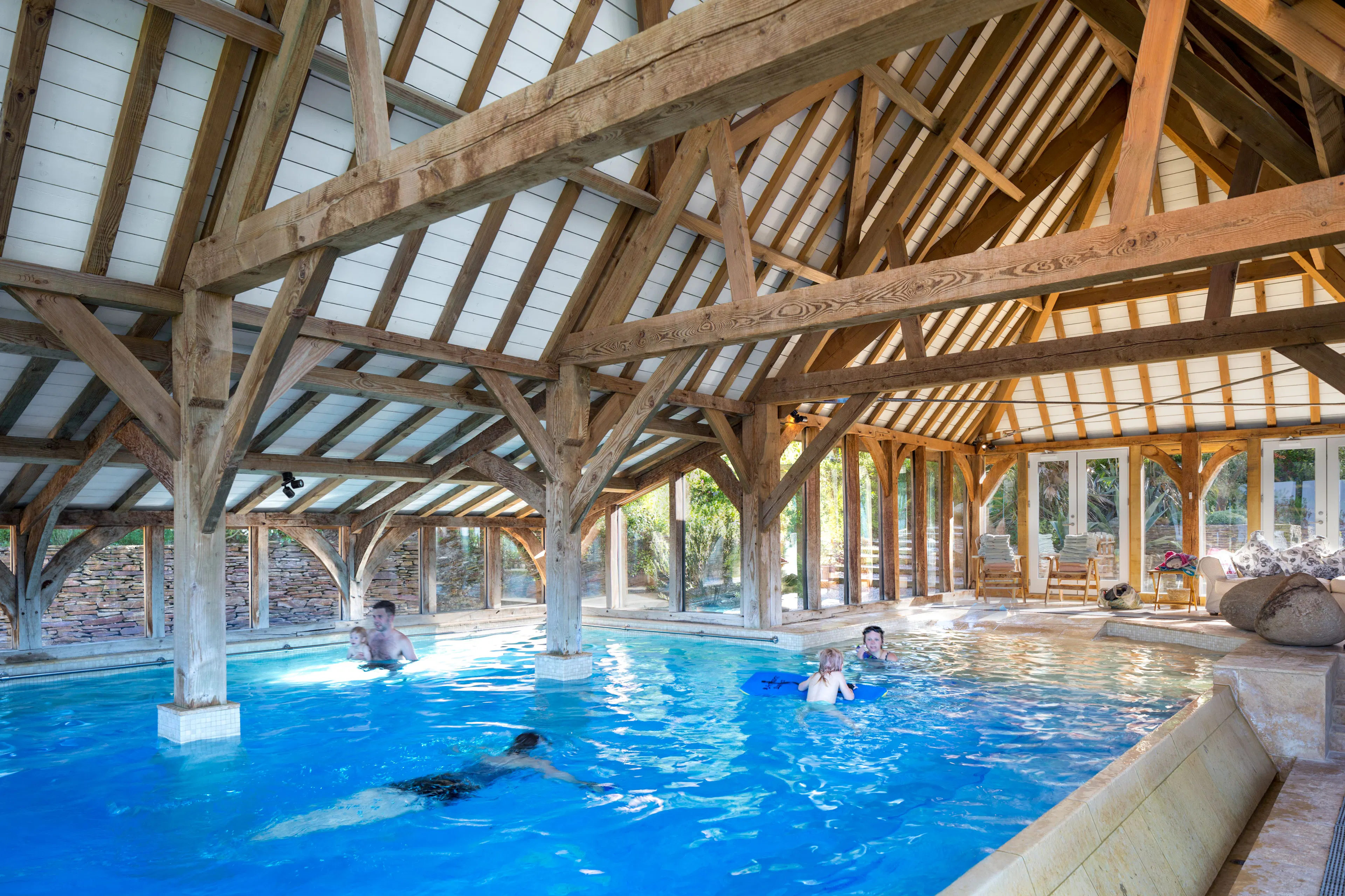 Children and adults enjoying and swimming in a Douglas fir framed swimming pool