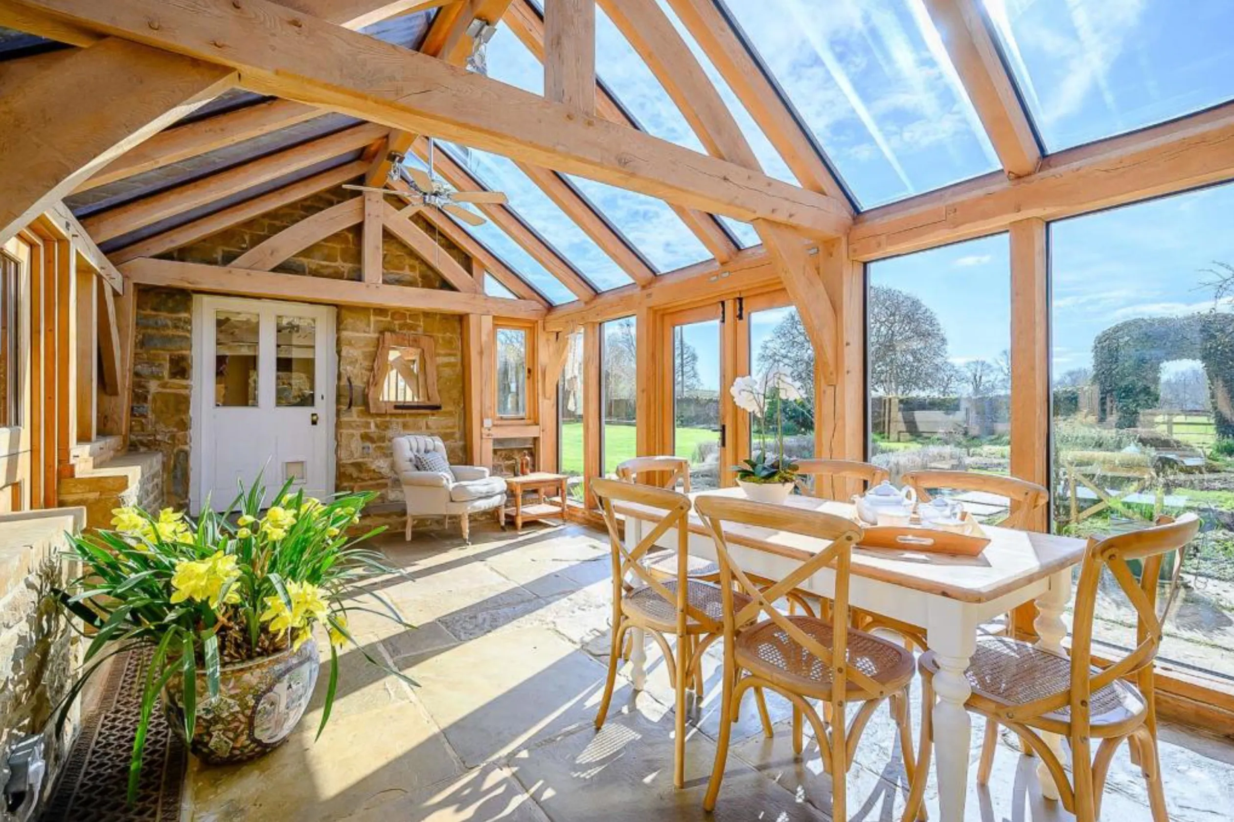 An oak framed sun room or garden room with sunlight coming through the glazing