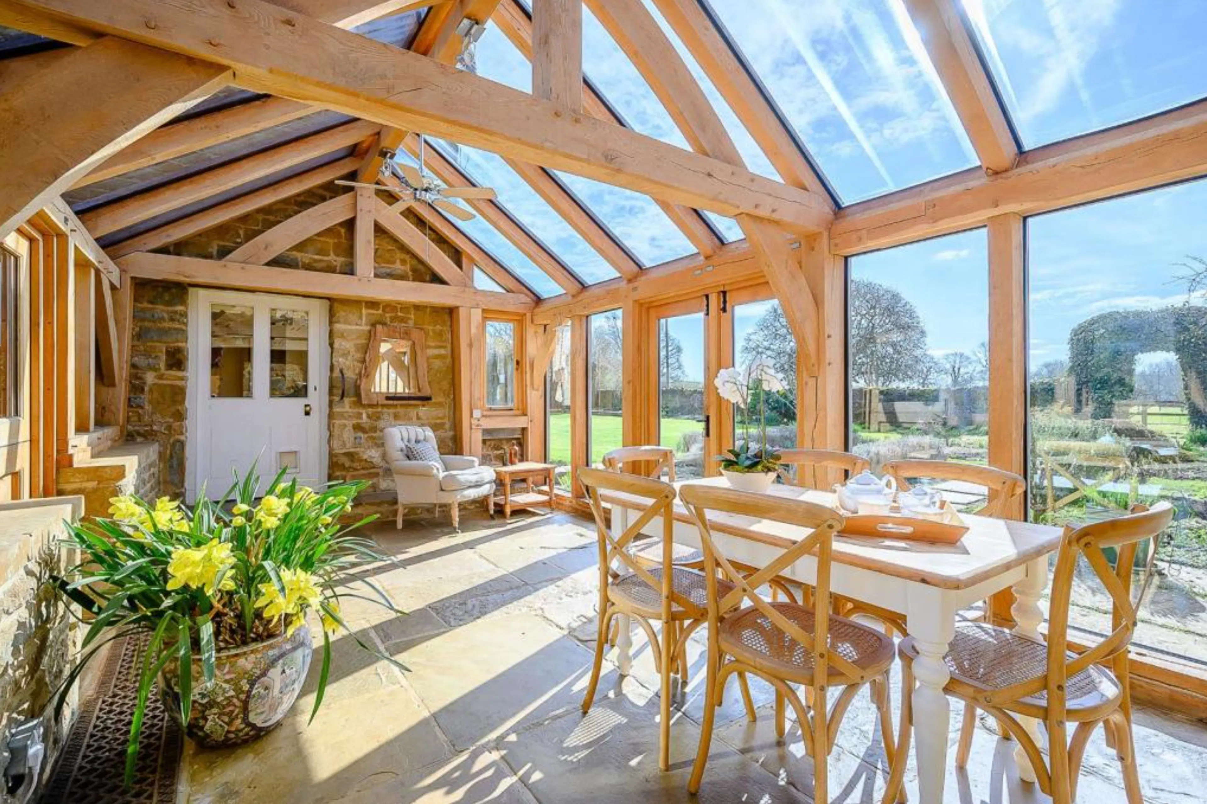 An oak framed sun room or garden room with sunlight coming through the glazing