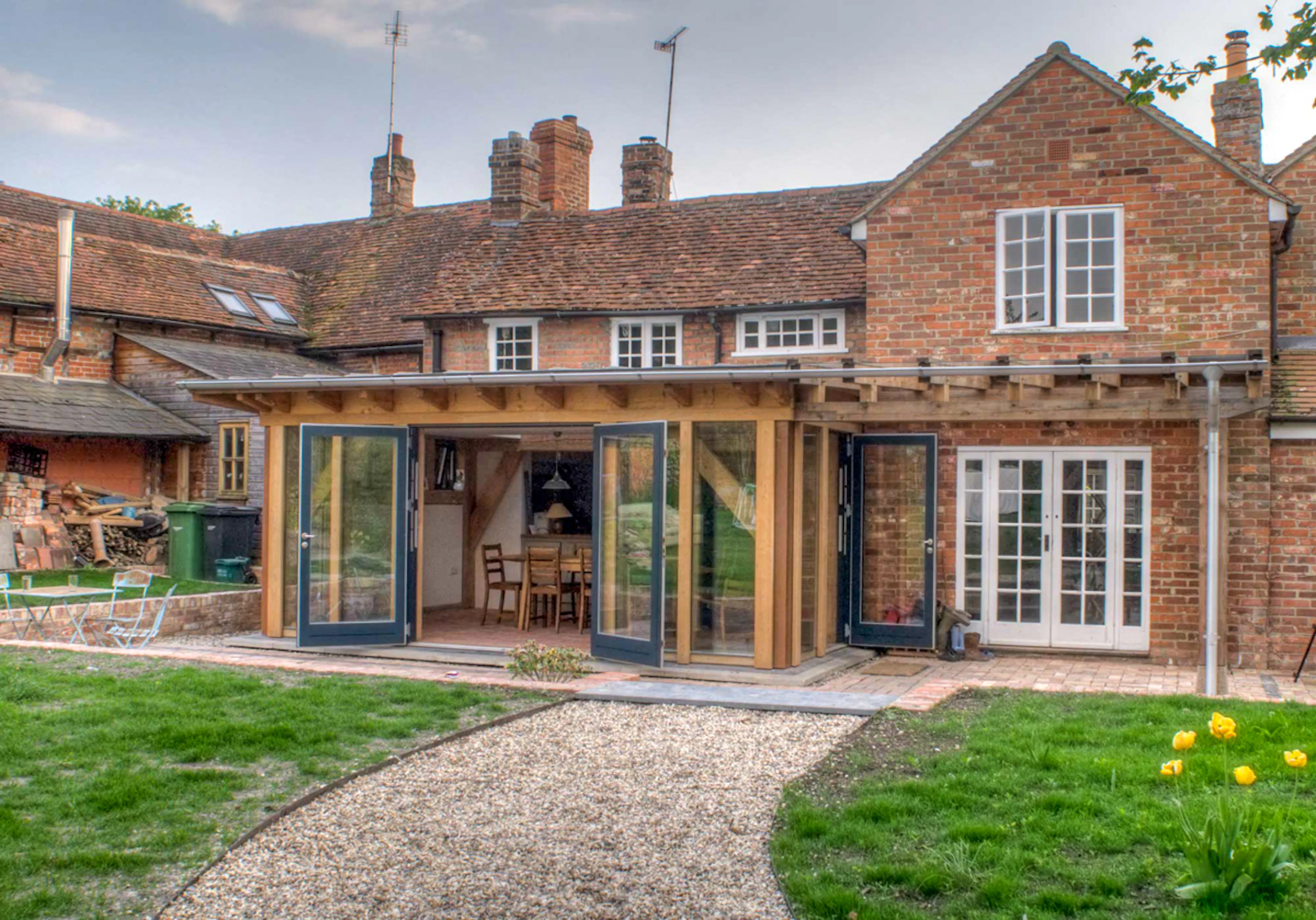 Exterior photo of a Douglas fir framed garden room with sliding doors opened