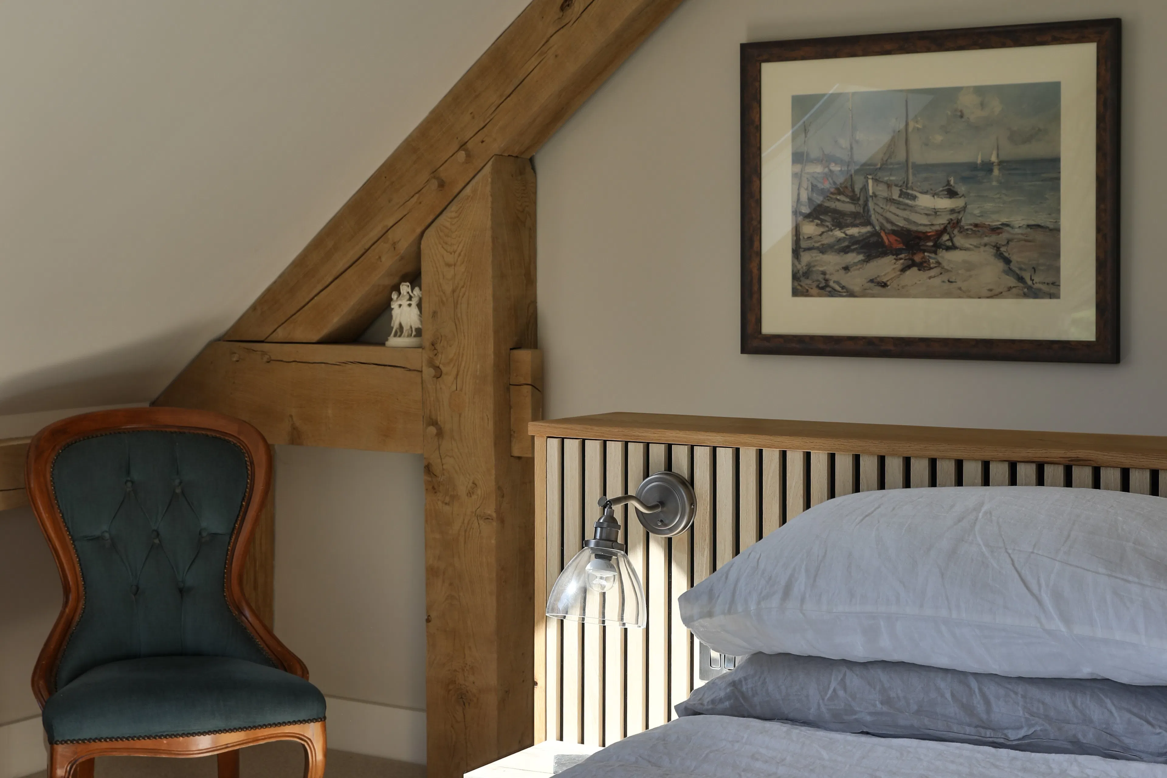 A bedroom in an oak frame home with an interrupted tie beam joint