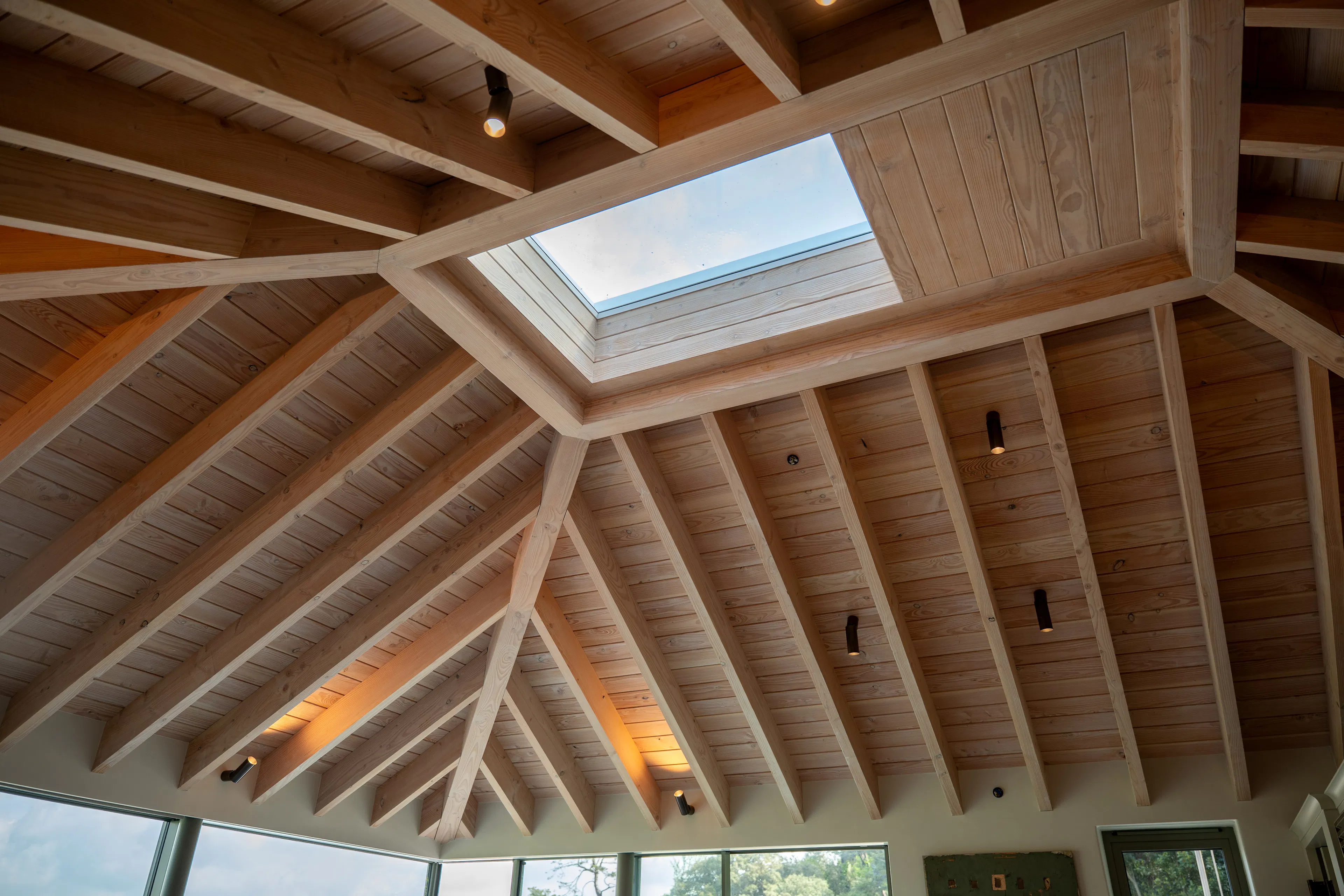Detail of the timber in a contemporary Douglas fir glulam framed kitchen extension and showing the rectangular roof light