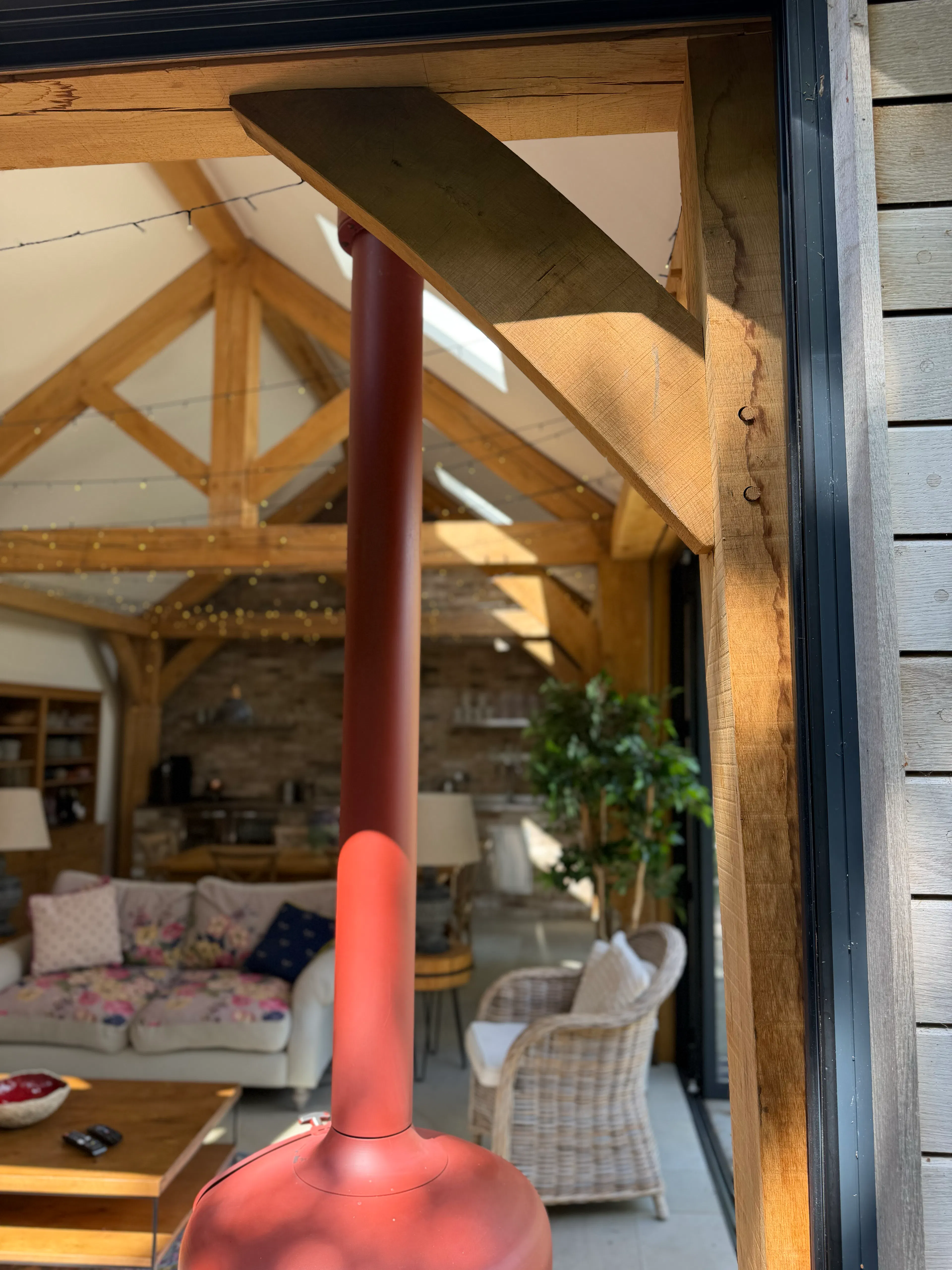 External view of a garden room with timber cladding and large bifold doors, showing detail of the façade and glazing