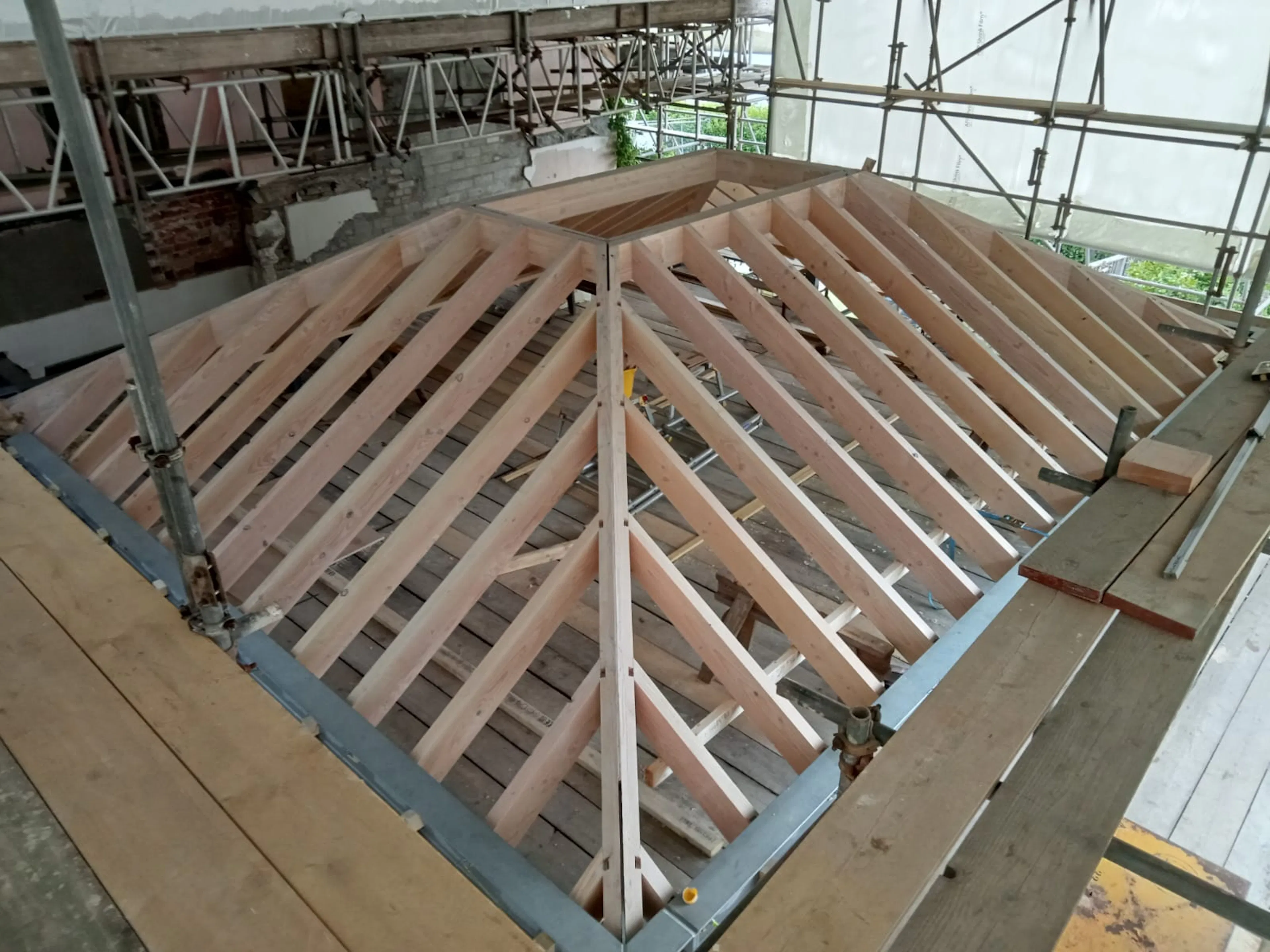 A timber framed ceiling with rectangle rooflight opening during construction