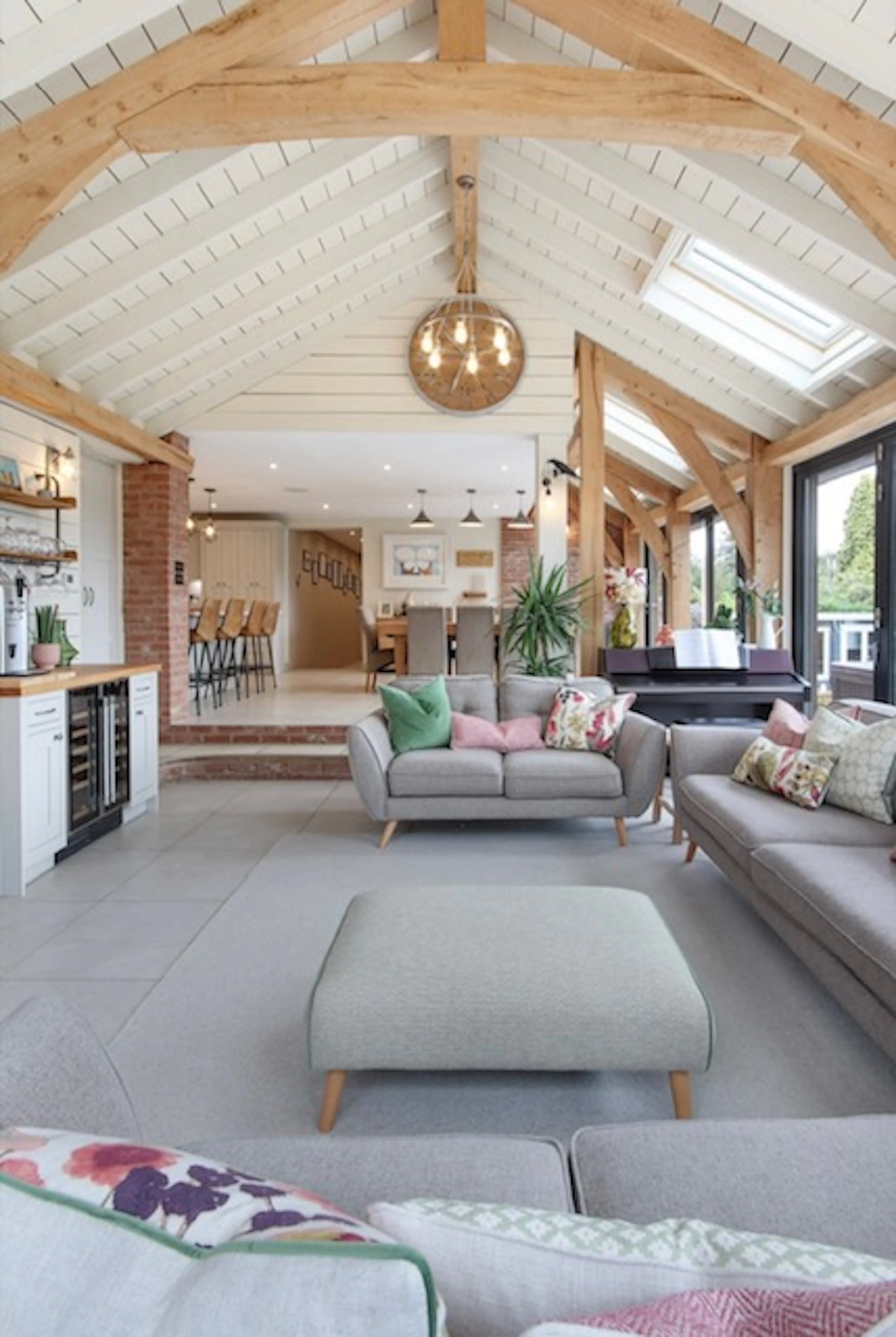 A modern oak framed extension encompassing an open plan family room and dining area with integrated glazing and roof lights providing lots of natural light.