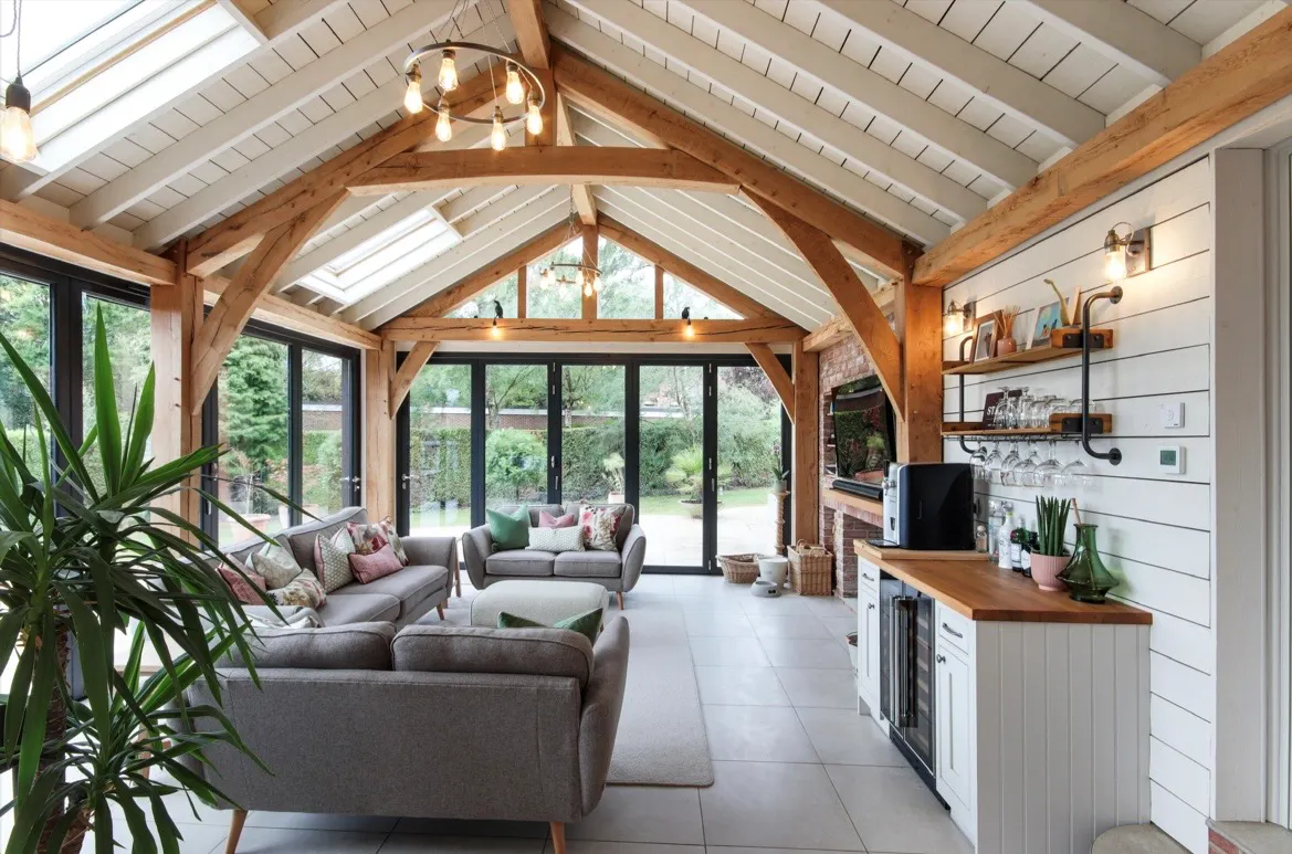 A modern oak framed extension family room with integrated glazing and roof lights providing lots of natural light.