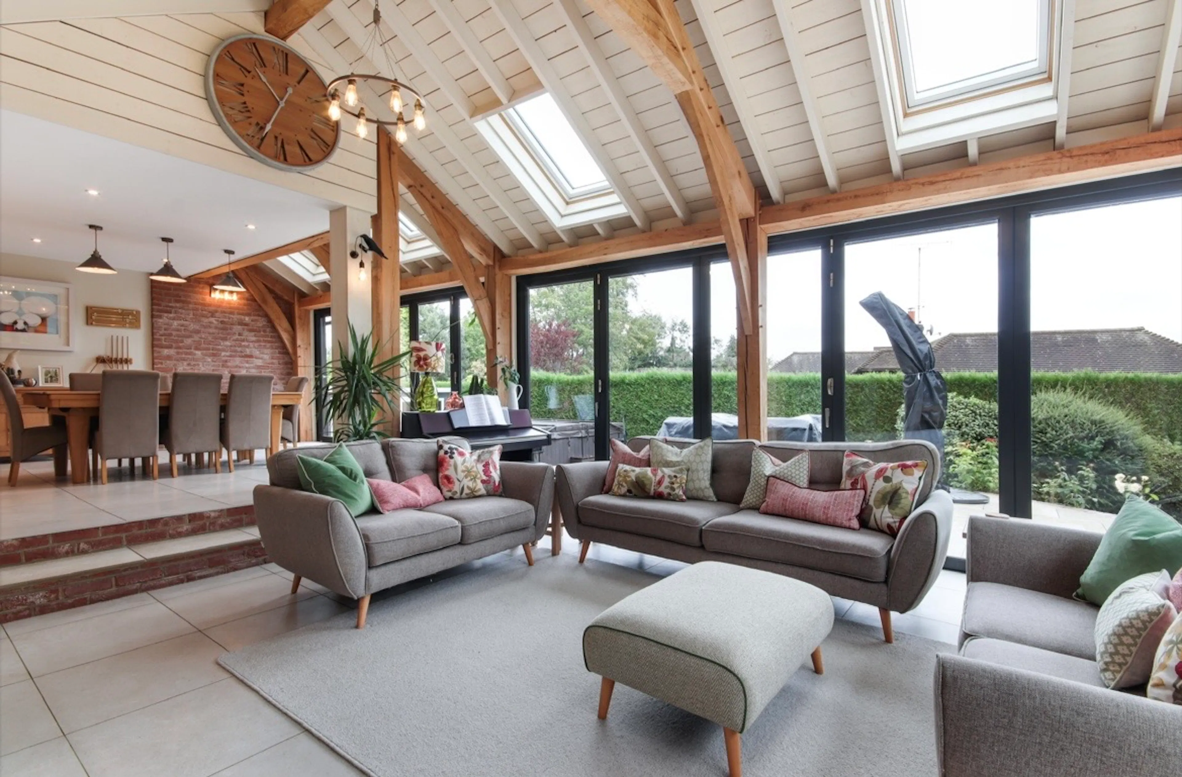 A modern oak framed extension encompassing an open plan family room and dining area with integrated glazing and roof lights providing lots of natural light.