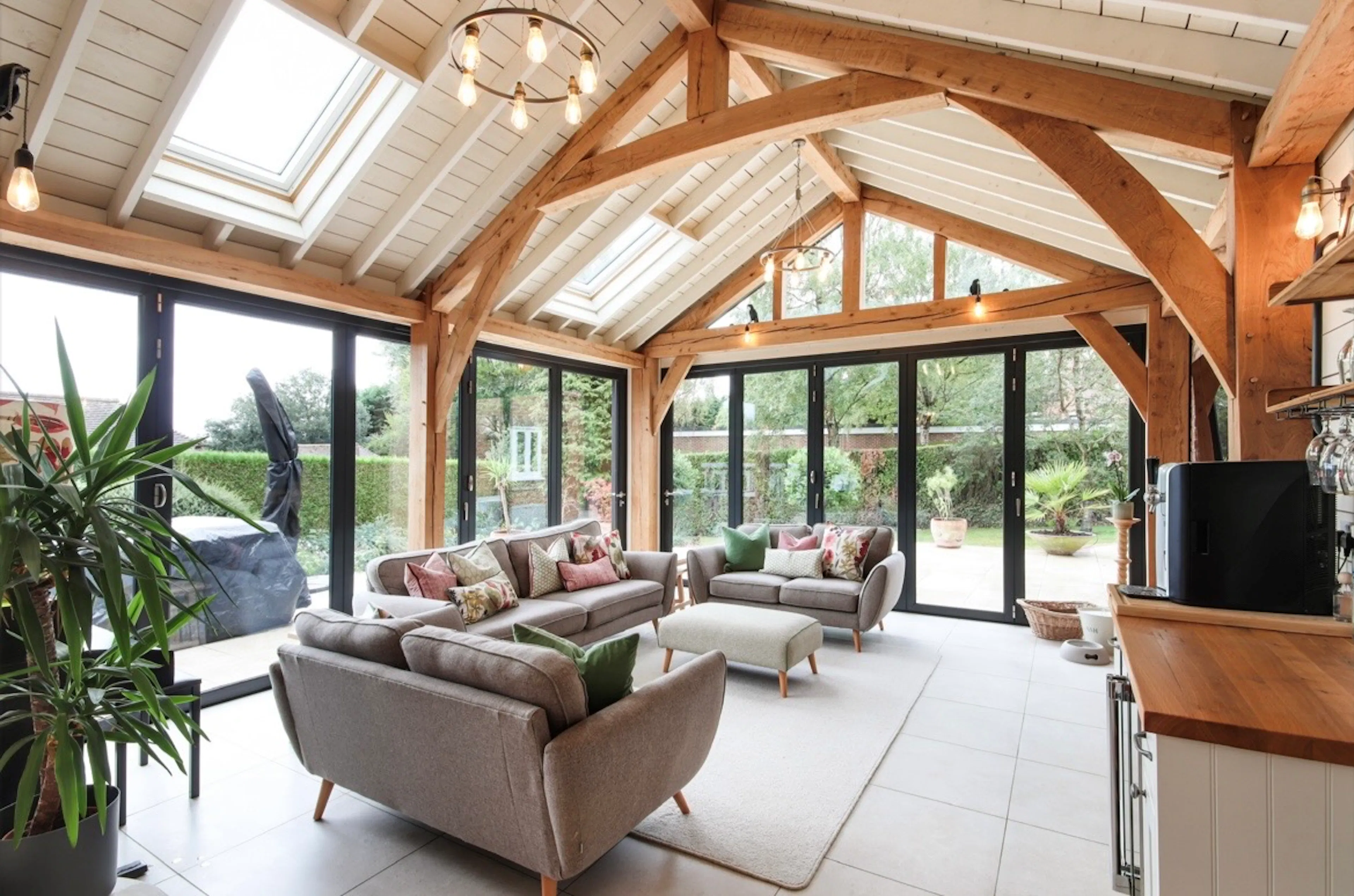 A modern oak framed extension family room with integrated glazing and roof lights providing lots of natural light.