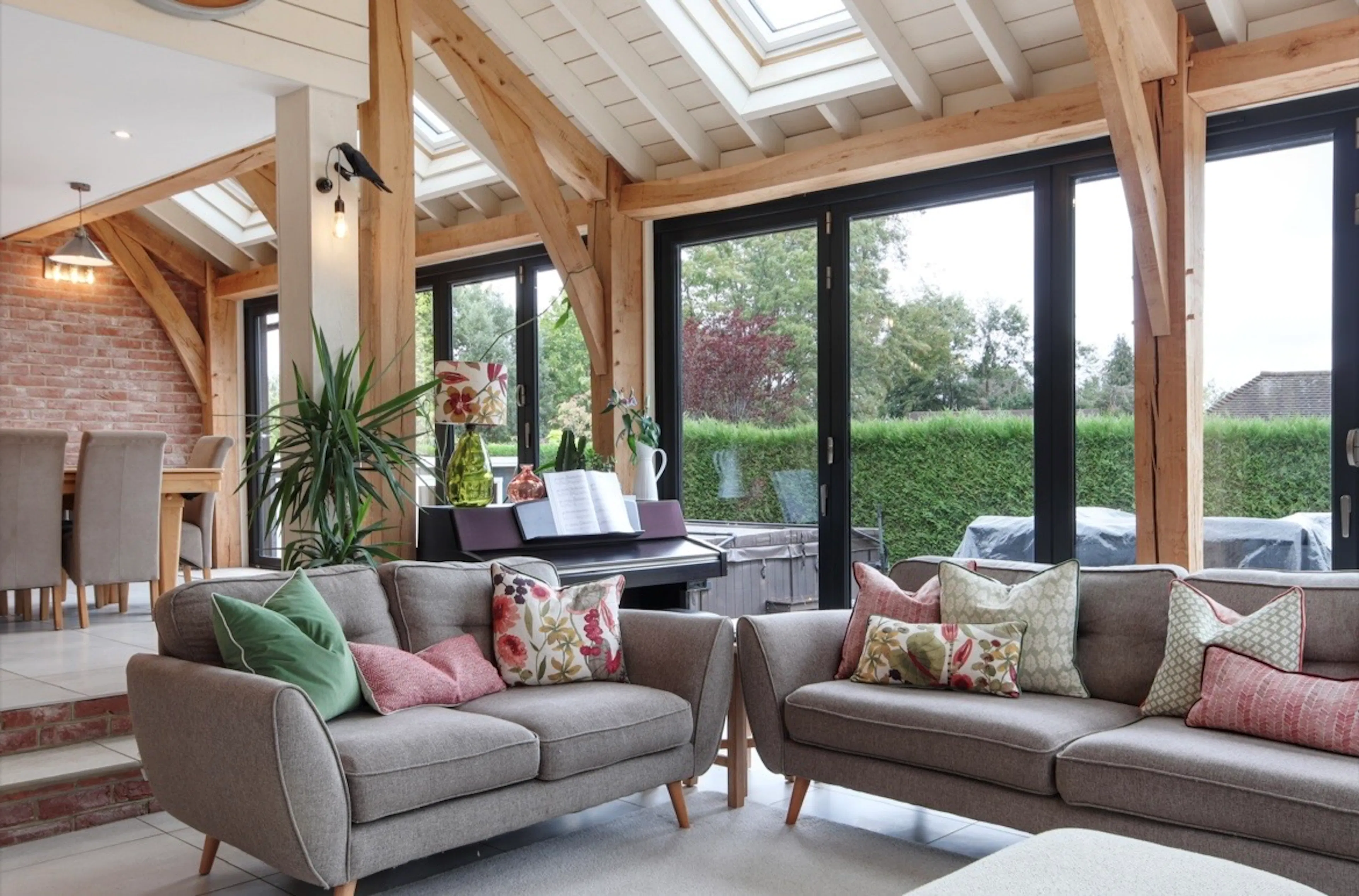 A modern oak framed extension encompassing an open plan family room and dining area with integrated glazing and roof lights providing lots of natural light.