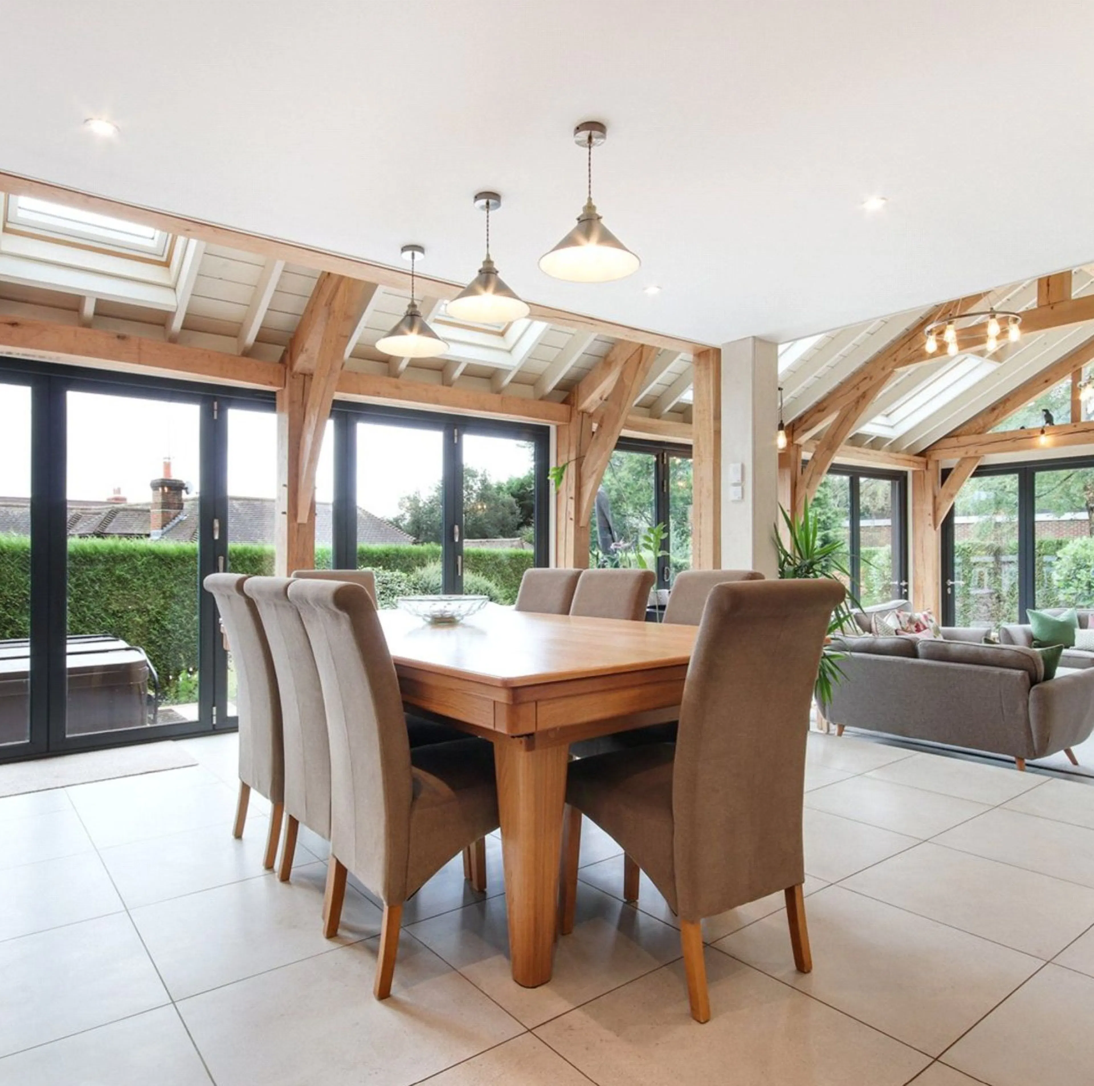 A modern oak framed extension encompassing an open plan family room and dining area with integrated glazing and roof lights providing lots of natural light.