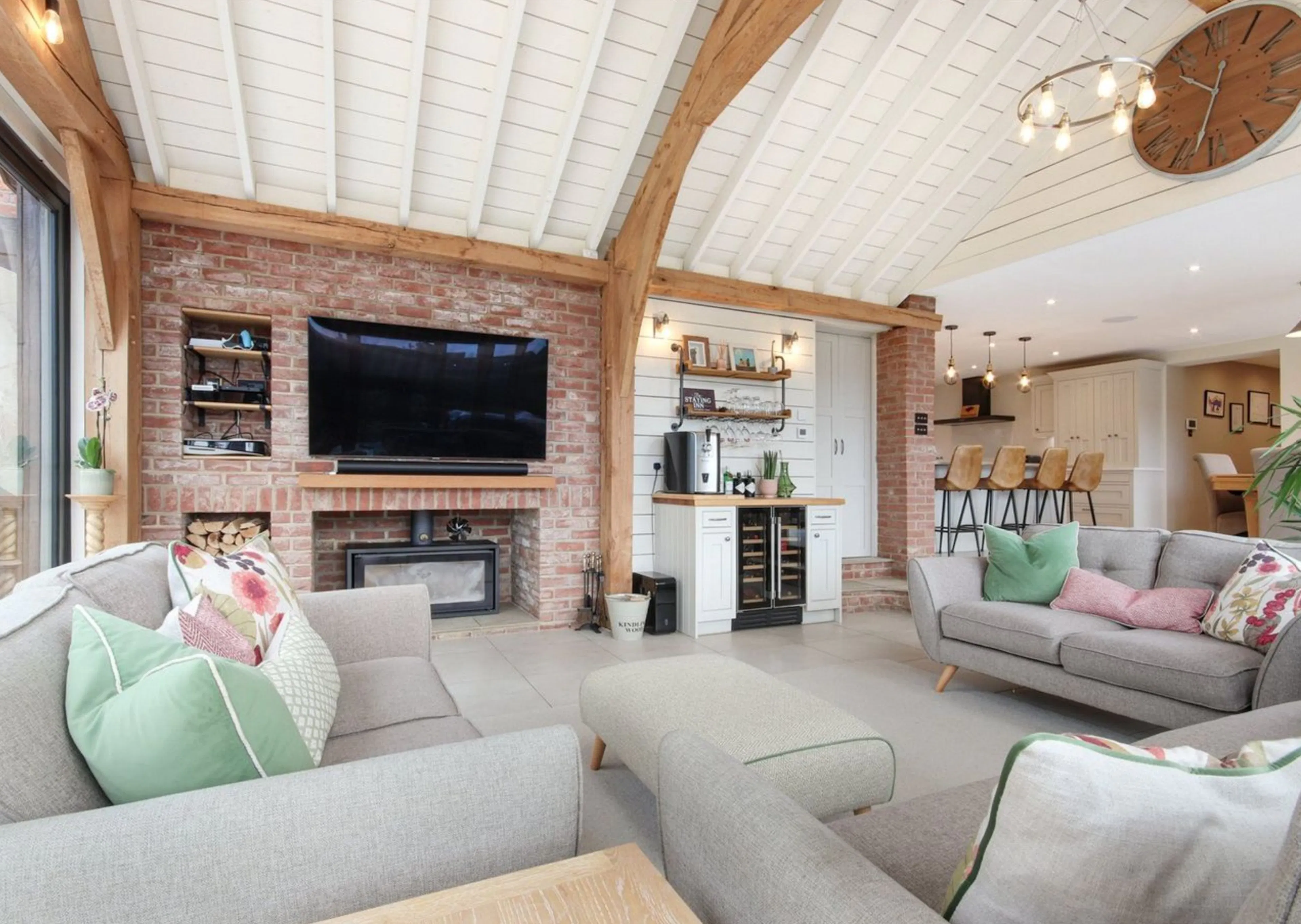A modern oak framed extension encompassing an open plan family room with white roof boarding.