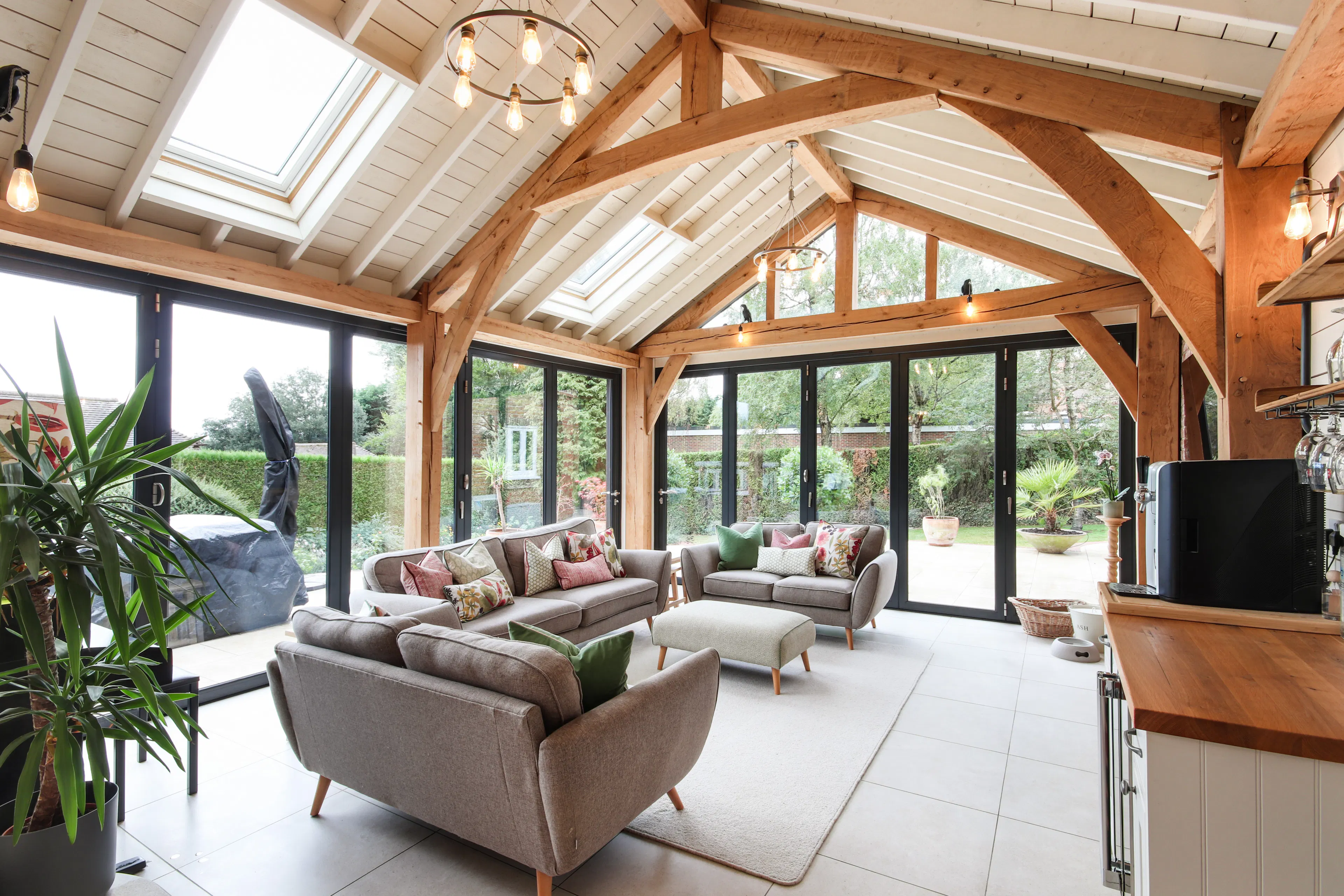 A modern oak framed extension family room with integrated glazing and roof lights providing lots of natural light.