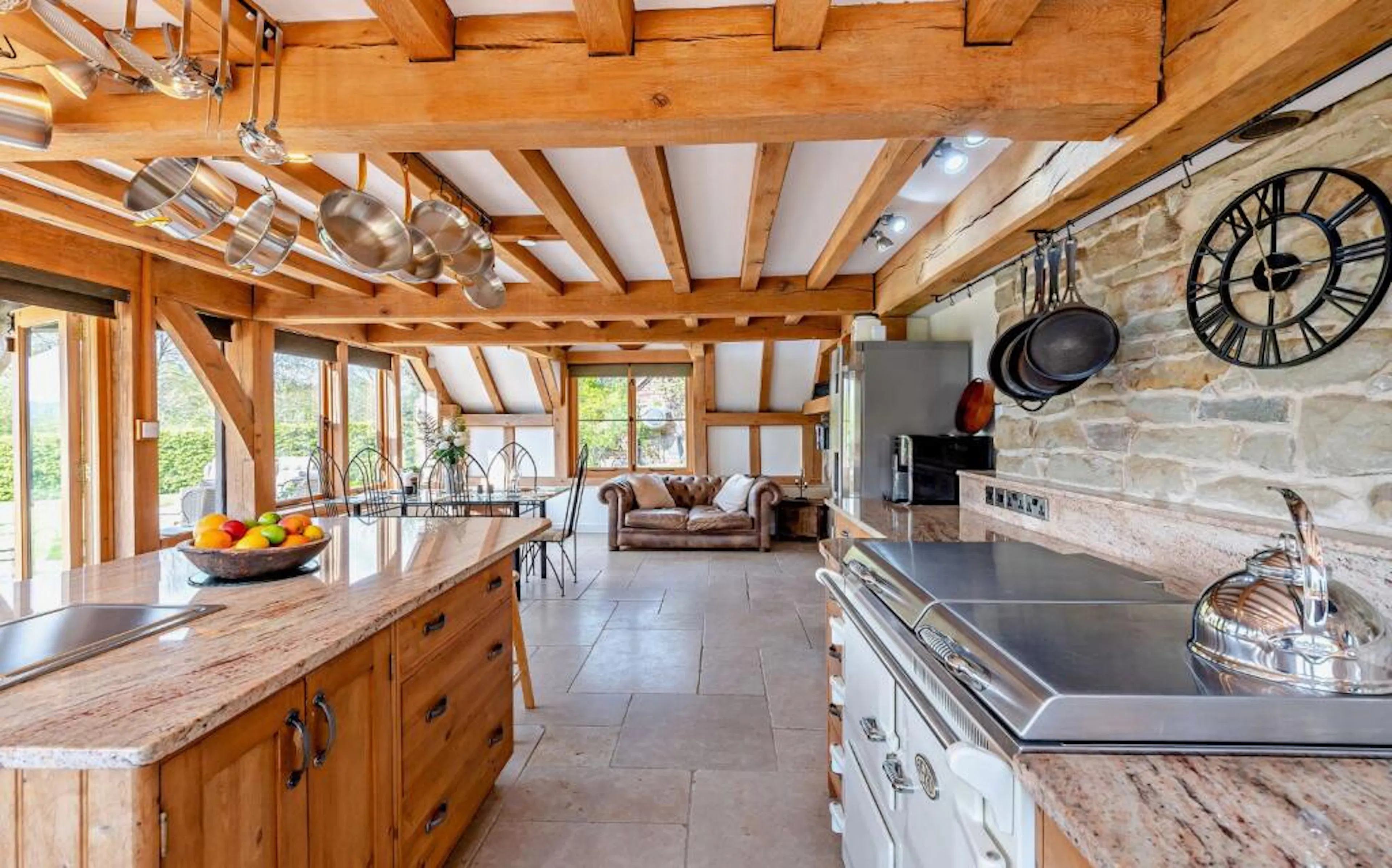 An open plan kitchen, dining and sitting room in an oak framed extension